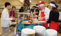 Col. Patrick Doherty, 4th Fighter Wing commander, and his family serve Christmas dinner to Airmen and families at the Southern Eagle Dining Facility on Seymour Johnson Air Force Base, N.C., Dec. 25, 2011. The Dohertys volunteered their time to build morale and give back to Airmen during the holidays. Approximately 150 people showed up to enjoy the Christmas dinner.  Doherty hails from Bellevue, Neb. (U.S. Air Force photo by Senior Airman Gino Reyes)