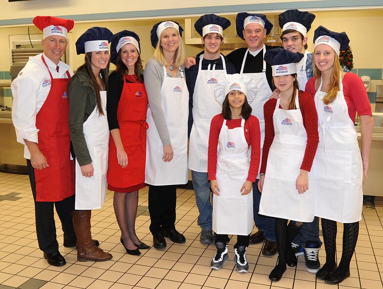 Col. Patrick Doherty, 4th Fighter Wing commander, and his family pose for a photo prior to serving Airmen Christmas dinner at the Southern Eagle Dining Facility on Seymour Johnson Air Force Base, N.C., Dec. 25, 2011. The dining facility prepared a Christmas meal with a large variety of food for Airmen on base. Doherty hails from Bellevue, Neb. (U.S. Air Force photo by Senior Airman Gino Reyes)
