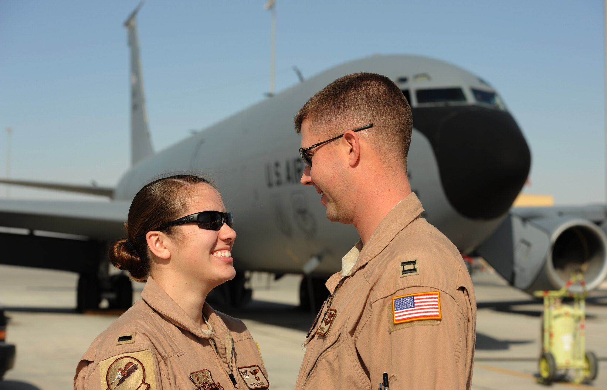 Capt. Timothy McBride and 1st Lt. Victoria McBride, 340 Expeditionary Air Refueling Wing pilots, stand in front of a KC-135 Stratotanker on the flightline here Dec. 28, 2011. The McBrides, married since 2010, unexpectedly reconnected during a night air refueling mission in Afghanistan on Christmas Day. Timothy, a native of Orland Park, Ill., and Victoria, a native of Renovo, Pa, are deployed from McConnell Air Force Base, Kansas. (U.S. Air Force photo/Staff Sgt. Nathanael Callon) 