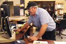 Jerry Cazeault signs in a customer at the Auto Skills Development shop on Seymour Johnson Air Force Base, N.C., Dec. 27, 2011. Signing customers in allows the shop to keep up with the $6 hourly rate charge for each bay. The shop has 13 bays for self-service work which includes use of the data system, a mechanic’s help if needed and all tools. Cazeault is a 4th Force Support Squadron auto skills development mechanic from Woonsocket, R.I. (U.S. Air Force photo by Senior Airman Whitney Stanfield)
