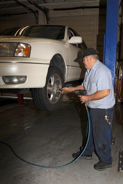 Jerry Cazeault tightens lug nuts with an impact gun during a brake change on Seymour Johnson Air Force Base, N.C., Dec. 27, 2011. There are four mechanics available to perform or assist with alignments, tire rotations and state inspections. The Auto Skills Development shop offers help to women and men that want to learn how to maintain a vehicle by themselves. Cazeault is a 4th Force Support Squadron auto skills development mechanic from Woonsocket, R.I. (U.S. Air Force photo by Senior Airman Whitney Stanfield)
