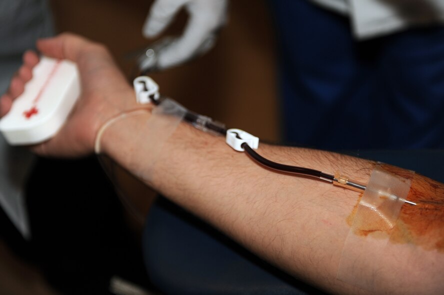 Blood is drawn from an Airman during an American Red Cross volunteer blood drive at Moody Air Force Base, Ga., Dec. 27, 2011. The American Red Cross also offers confidential services such as counseling, guidance, information and referrals to all active duty, National Guard and Reserve military personnel and their families. (U.S. Air Force photo by Staff Sgt. Ciara Wymbs/Released)