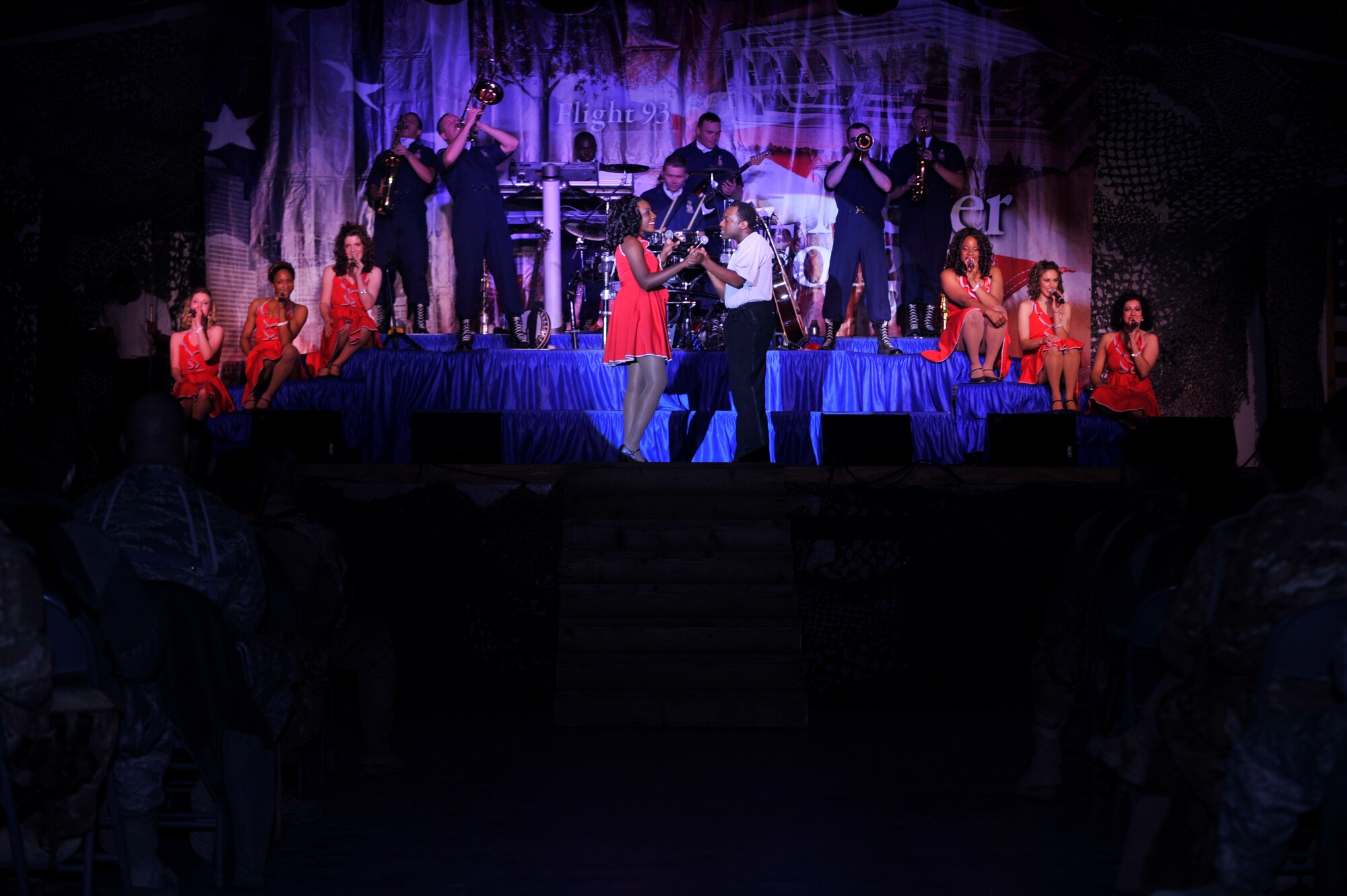 BAGRAM AIRFIELD, Afghanistan— Two Tops in Blue 2011 members perform a routine at Bagram Airfield, Dec 24, 2011.Members of Tops in Blue are all active-duty members who volunteered for the program as a on- year permissive TDY that is the Tops in Blue program. . (U.S. Air Force photo/A1C Ericka Engblom)
