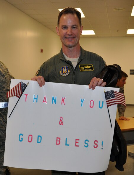 Col. Eric Overturf, commander of the 442nd Fighter Wing, holds a sign given to him by a student from Wellington, Mo. The student and her family came to Whiteman to support the reservists of the wing when they deployed to Afghanistan, Dec. 28, 2011. The 442nd FW is an A-10 Thunderbolt II Air Force Reserve unit at Whiteman Air Force Base, Mo. Approximately 130 reservists deployed in support of Operation Enduring Freedom. (U.S. Air Force photo/ Senior Airman Wesley Wright)