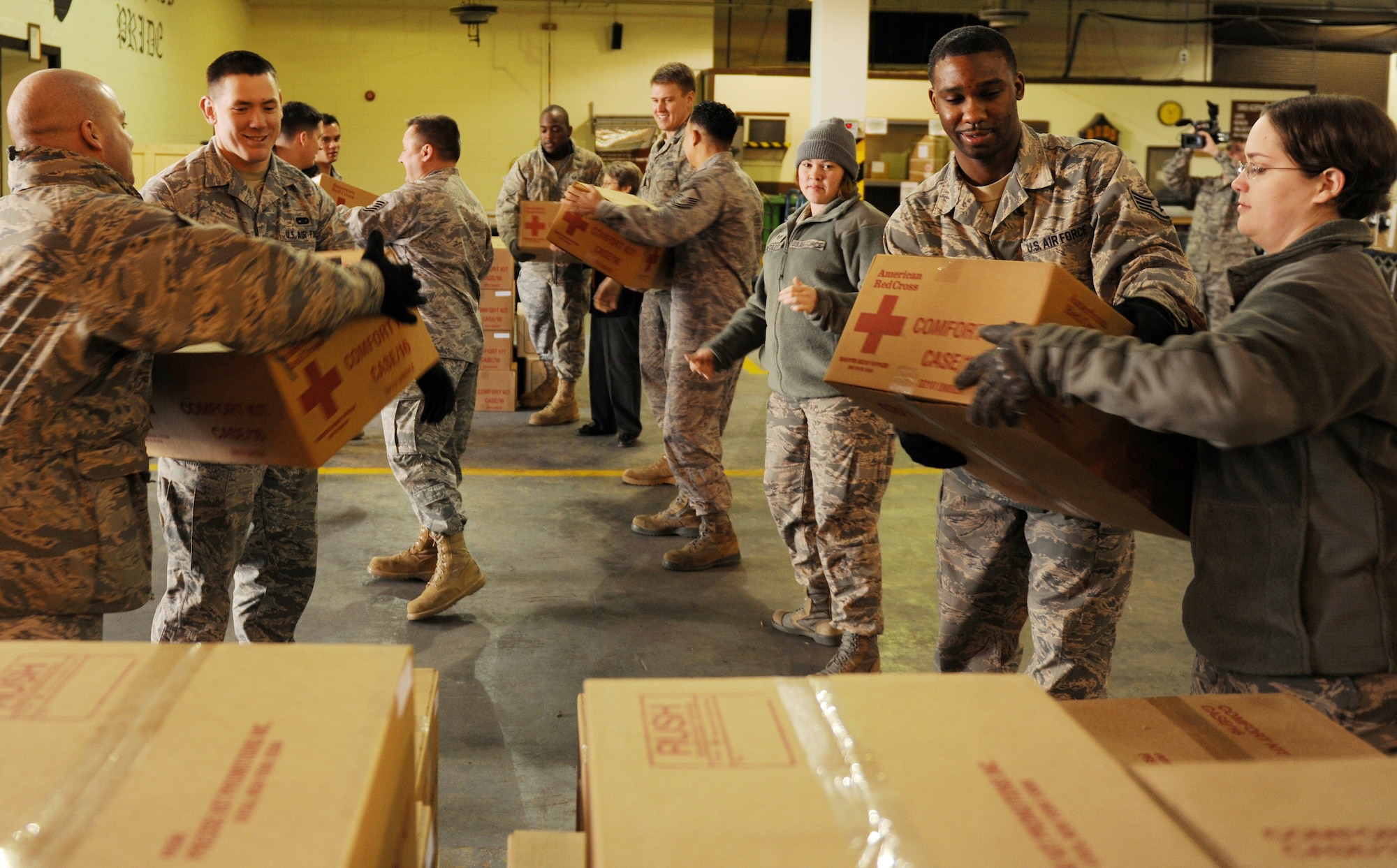 Volunteers unload comfort kits to be used in case the base houses authorized voluntary departing family members from Japan at Kunsan Air Base, Republic of Korea, March 23, 2011. The American Red Cross delivered 1,500 comfort kits to Kunsan which included items such as shampoo, toothpaste, wash cloths and other various items. (U.S. Air Force photo by Tech. Sgt. Jonathan Pomeroy/Released)