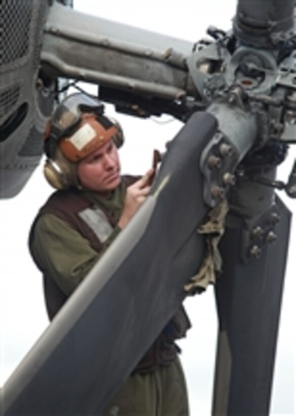 Lance Cpl. David J. Pyfer conducts corrosion control maintenance on a CH-53E Super Stallion with Marine Medium Helicopter Squadron 268 (Reinforced) aboard the USS Makin Island on Dec. 28, 2011.   The squadron is the aviation combat element for the 11th Marine Expeditionary Unit that deployed on Nov. 14 aboard the USS Makin Island, the USS New Orleans and the USS Pearl Harbor departing from Singapore as part of a scheduled deployment to the western Pacific and Middle East regions.  