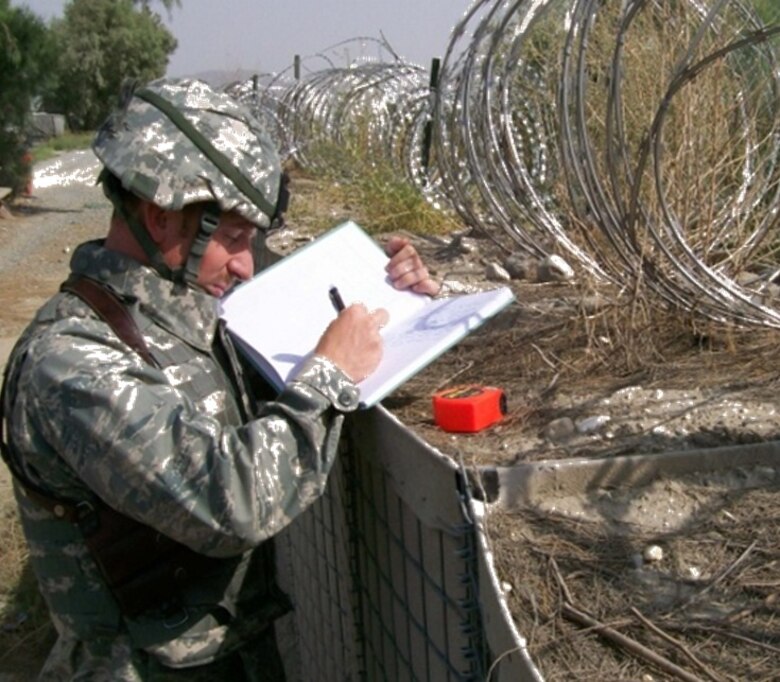 A member of the 240th Civil Engineer Flight, 140th Wing, Colorado Air National Guard, records data at a deployed location. (U.S. Air Force Photo)