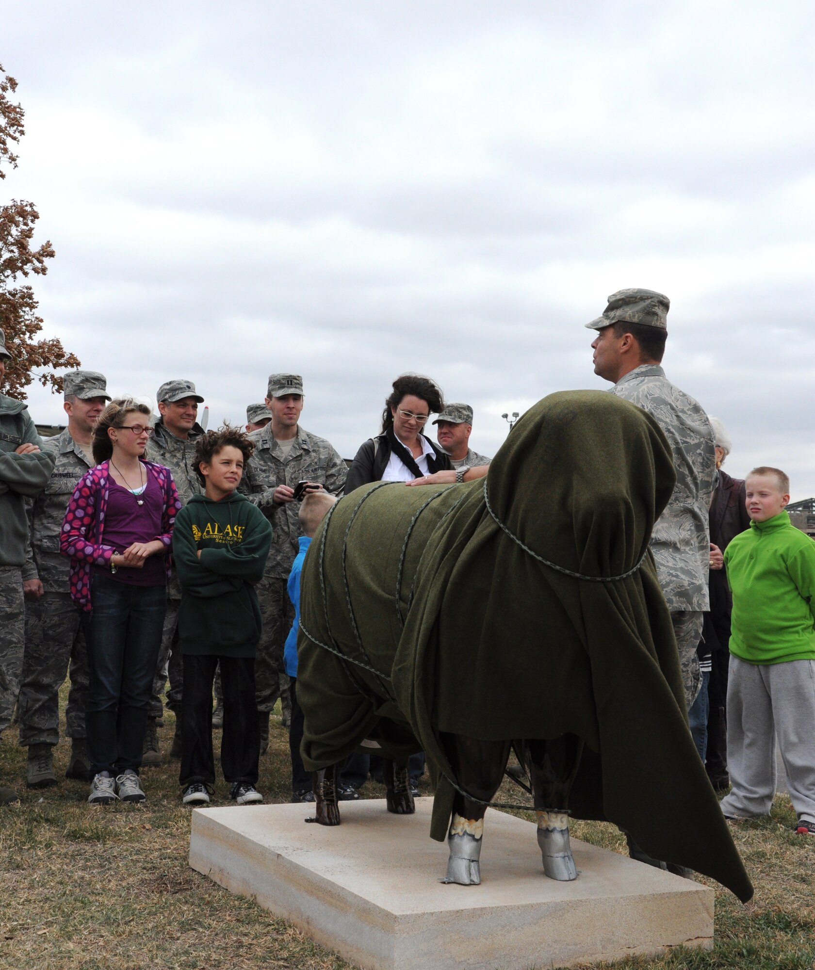 GOODFELLOW AIR FORCE BASE, Texas—Col. Mark Damiano, 17th Training Wing Commander, addresses base and San Angelo attendees just before he and Sharon Smith, Team Goodfellow spouse, unveil the base’s newest servicemember in front of the Jacobson Gate Nov. 18, 2011. Smith is the artist who painted ‘Lt. Col. Ewe Little,’ a fiberglass sheep, which is now part of a network of painted sheep on display throughout San Angelo. The sheep represent a part of the heritage of San Angelo, which was once the sheep capital of the world. (U.S. Air Force photo/Airman 1st Class Jessica Keith)