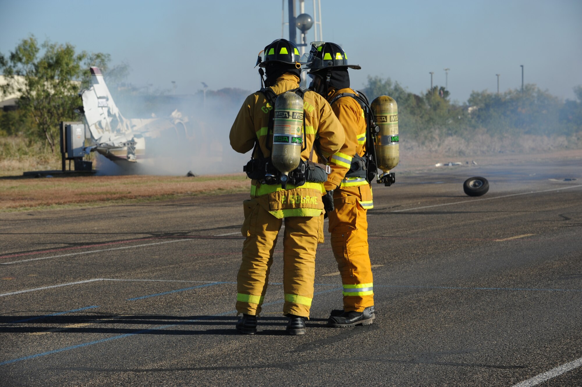 GOODFELLOW AIR FORCE BASE, Texas -- Firefighters from the 17th Civil Engineer Squadron survey the simulated wreckage of a crop duster during Exercise Scarlet Hawk 11-12, Nov. 16, 2011. The exercise was in conjunction with the base’s 2011 Compliance Inspection. Team Goodfellow received and excellent. (U.S. Air Force photo/Staff Sgt. Laura R. McFarlane)