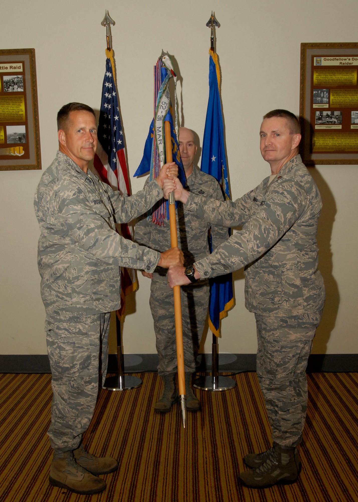 GOODFELLOW AIR FORCE BASE, Texas-- (From left:) Col. Paul Bugenske, 17th Mission Support Group Commander, passes the 17th Security Forces Squadron guidon to Maj. Dennis Turriff, who assumed command of the 17th SFS from Maj. James Masoner during a change of command ceremony July 6, 2011 at the Events Center here. (U.S. Air Force photo/Senior Airman Tong Duong)

