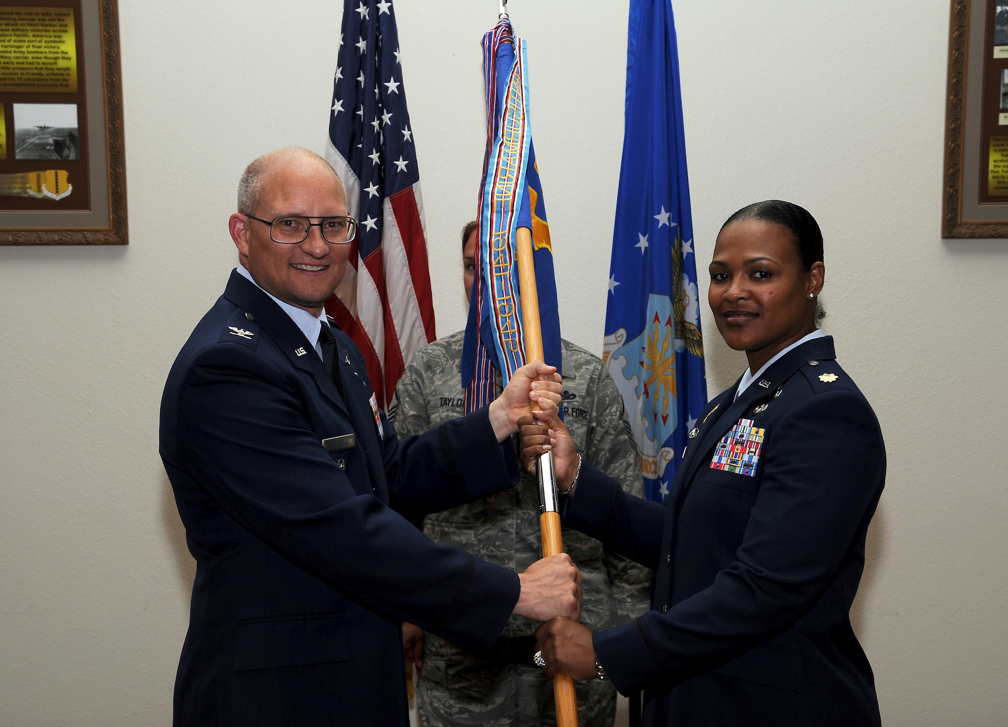 GOODFELLOW AIR FORCE BASE, Texas-- (From left:) Col. William Golladay, 17th Training Wing Vice Commander, passes the 17th Comptroller Squadron guidon to Maj. Yolanda Taylor, who assumed command of the 17th CPTS from Maj. Michael Goodman during a change of command ceremony July 22, 2011 at the Events Center here. (U.S. Air Force photo/Airman 1st Class Michael Smith)