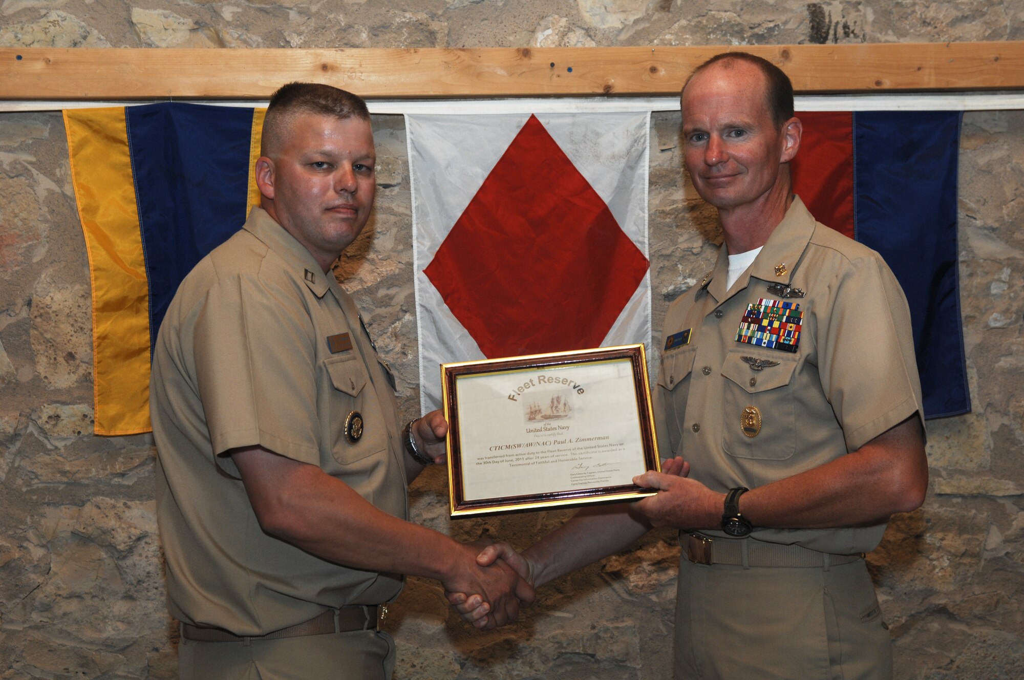 SAN ANGELO, Texas-- Navy Lt. Lonnie Griffith, Center for Information Dominance Detachment Commander, officiates at Master Chief Petty Officer Paul Zimmerman’s retirement ceremony June 3, 2011 at Fort Concho. Chief Zimmerman transferred to the Fleet Reserves after 24 years of active service in the U.S. Navy. (U.S. Air Force photo/Staff Sgt. Laura R. McFarlane) 