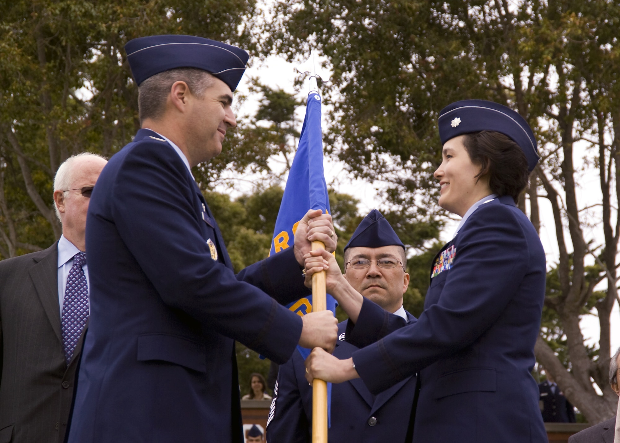 PRESIDIO OF MONTEREY, Calif.-- Col. Thomas Geary, 17th Training Wing Commander passes the guidon to incoming 517th Training Group Commander, then Lt. Col. Laura Ryan, during the Change of Command ceremony June 9, 2011. (U.S. Air Force photo/Sal Marullo)