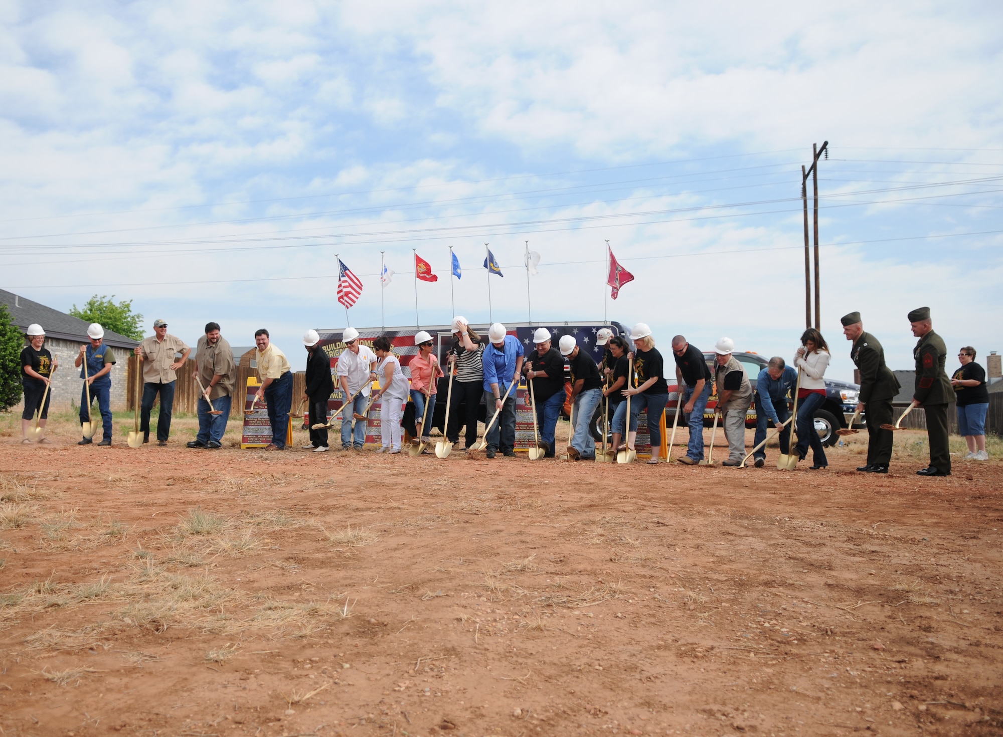 GOODFELLOW AIR FORCE BASE, Texas — Members of Team Goodfellow, Operation FINALLY HOME, Home Builders Association of San Angelo, Clark Construction, San Angelo dignitaries and community members help break ground on a 2000 square feet custom built mortgage-free home for Retired Lance Cpl. Samuel Marley and his family during a ceremony held, April 9. (U.S. Air Force photo/Staff Sgt. Heather Rodgers)