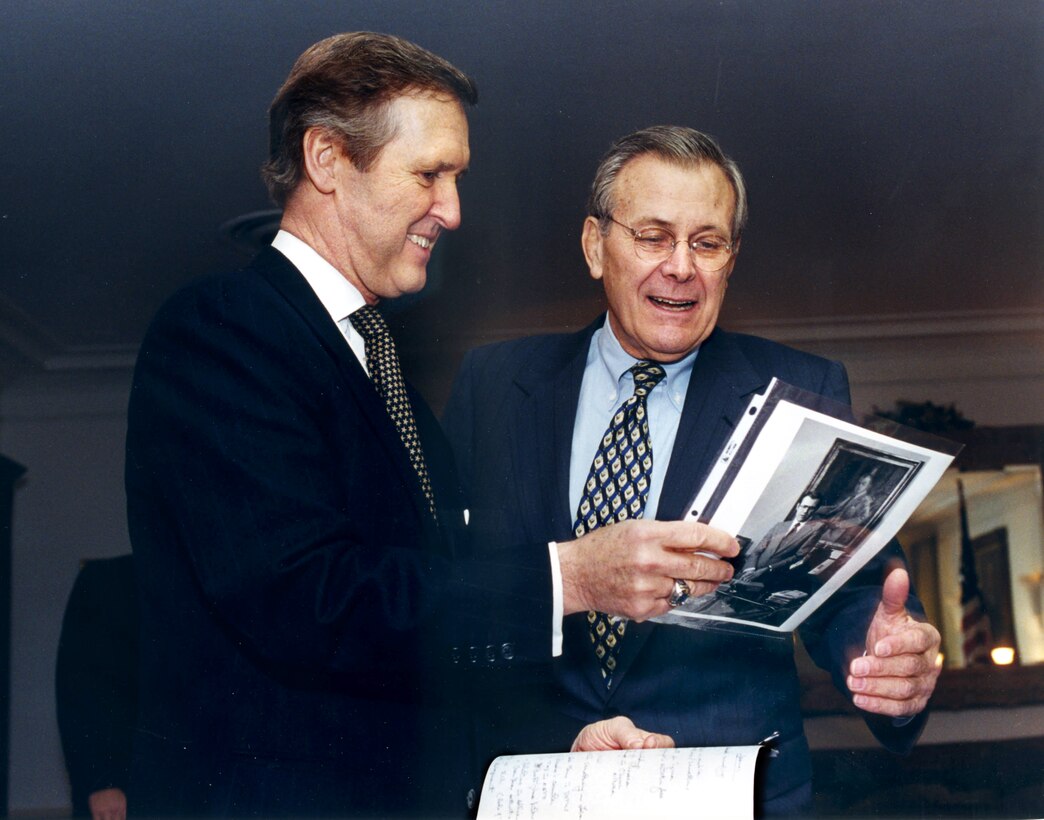 When Donald H. Rumsfeld came to the Pentagon on Jan. 5, 2001, for his first transition meeting with outgoing Secretary of Defense William Cohen, Defense Department photographer Robert D. Ward suggested to Cohen that they might show Rumsfeld some of Ward's photos from his first term as defense secretary.  Cohen liked the idea and placed eight of the photos in the desk drawer.  When Rumsfeld came in, Cohen remarked that not much had changed since he was last there.  He opened some of the drawers and then said "Oh, I think you left some old photos behind."  They had a good laugh looking over the 26 year-old pictures.