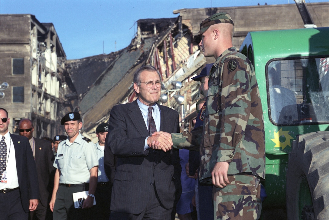 The day after the 9/11 terrorist attack on the Pentagon Defense Secretary Donald H. Rumsfeld and President George W. Bush visited the impact site to thank the workers there both military and civilian for the work they were doing in search and recovery,  Sept. 12, 2001.