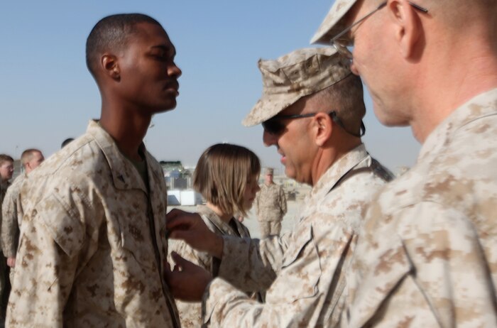 Lance Cpl. Markevis J. Seth, a native of Wilmington, Del., receives a Navy and Marine Corps Achievement Medal from Brig. Gen. Michael G. Dana, the commanding general for 2nd Marine Logistics Group (Forward), during a ceremony aboard Camp Leatherneck, Afghanistan, Dec. 30. In addition to assisting with the handling and processing of more than 3 million pounds of mail, Seth took on the additional responsibility of ensuring more than 3,000 shipping containers were prepared for transportation to outlaying forward operating bases. (U.S. Marine Corps photo by Sgt. Justin J. Shemanski)