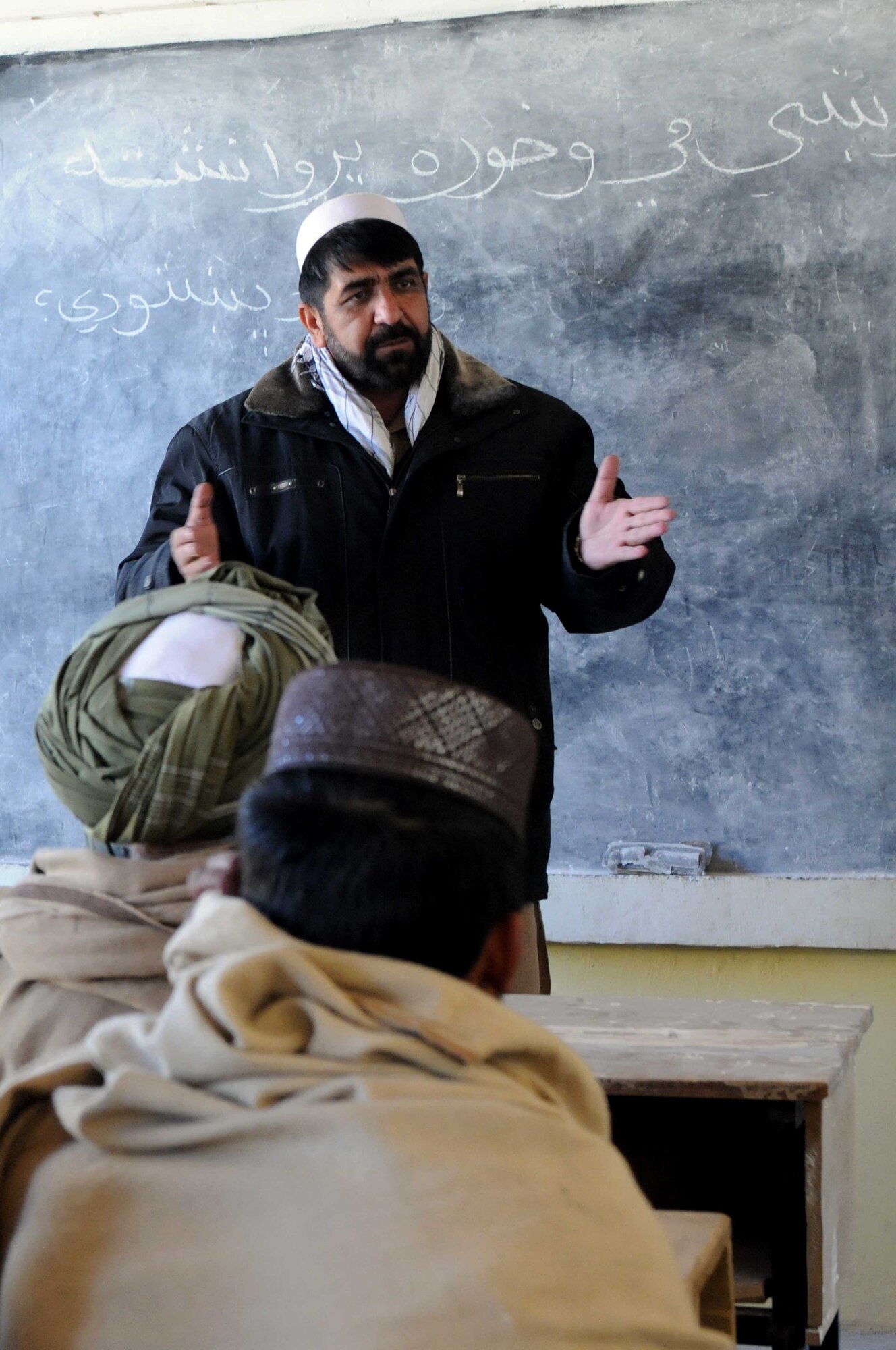 PAKTYA Province, Afghanistan—Zabihullah, Paktya Province director of livestock, speaks with Tandan Village elders during a village outreach mission in Paktya Province Dec. 28. Village outreach missions enable leaders of the Government of the Islamic Republic of Afghanistan to directly address provincial and local concerns.  (U.S. Air Force Photo by 1st Lt. Cammie Quinn, Paktya Provincial Reconstruction Team Public Affairs) 