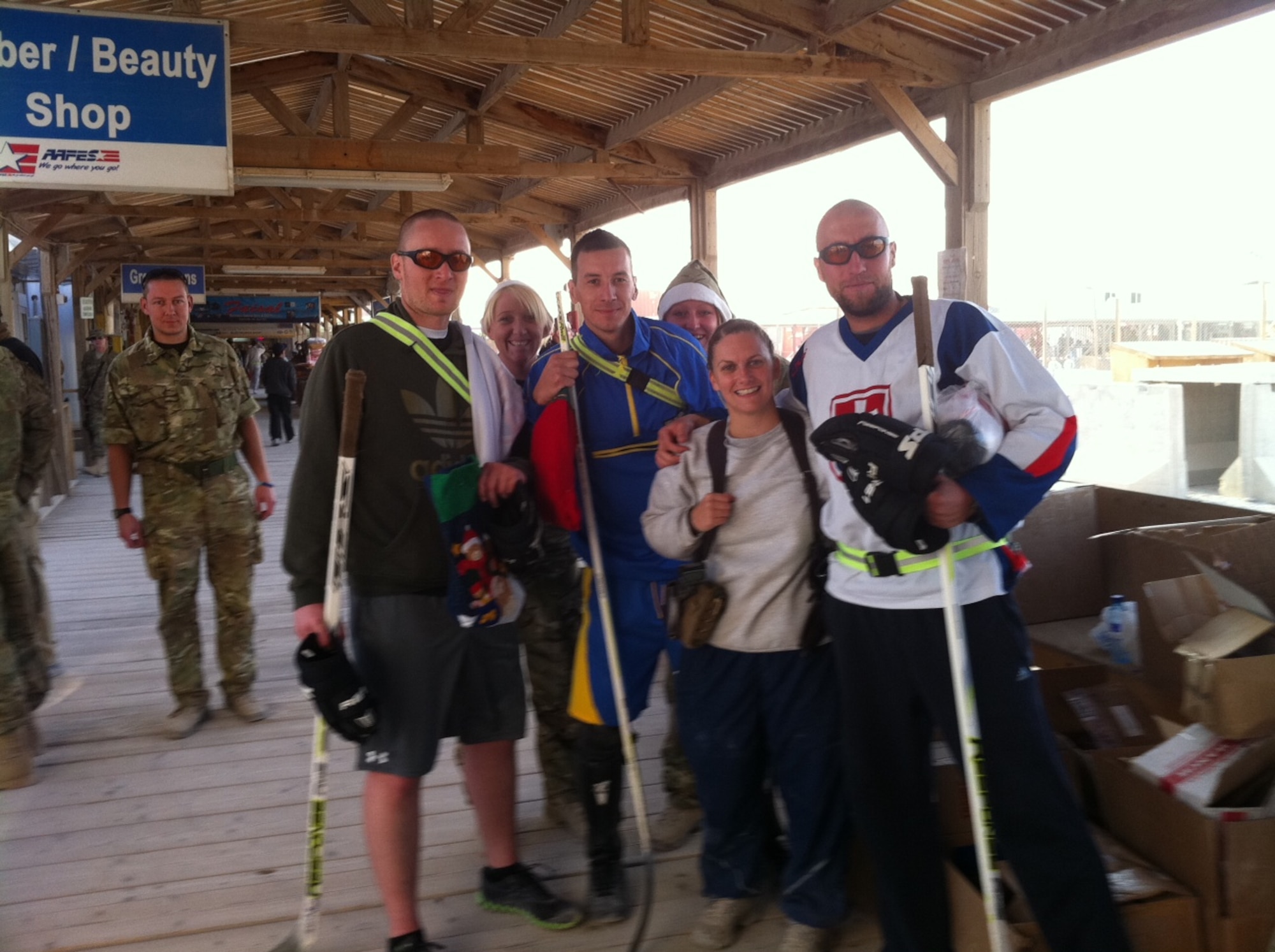 KANDAHAR AIRFIELD, Afghanistan -- A team of Slovakian hockey players pose with several stocking volunteers at the boardwalk at Kandahar Airfield, Afghanistan, Dec. 25, 2011. Chaplain (Capt.) Kevin Humphrey, a 451st Air Expeditionary Wing chaplain, and his team of volunteers received more than 3,400 stockings to give to fellow Airmen and coalition partners at Kandahar. (Courtesy photo)