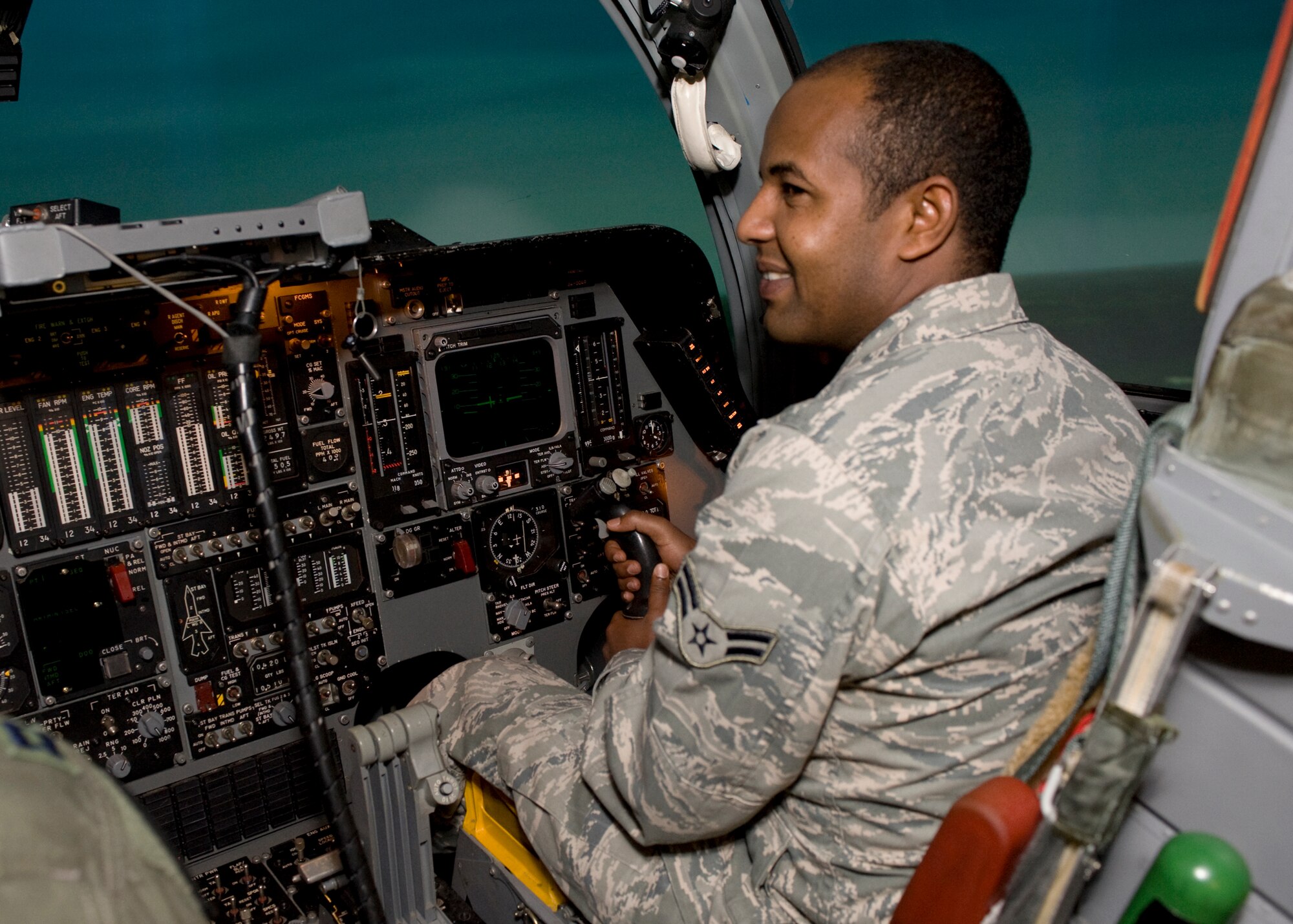 Airman 1st Class Tefera Workneh, Air Force Financial Services Center station gain technician, experiences the thrill of flying a B-1B in the Weapon Systems Trainer on Ellsworth Air Force Base, S.D., Dec. 29, 2011.  He was one of 144 people who signed up for the tours, designed to give people a better understanding of what it takes to fly and operate the B-1B.  (U.S. Air Force photo by Airman 1st Class Anania Tekurio/released)