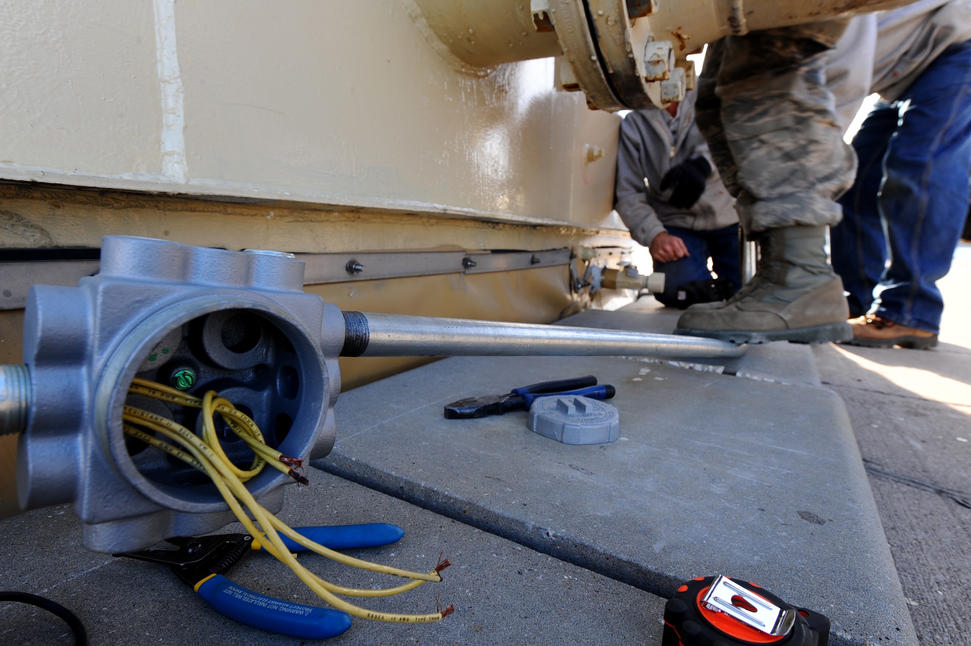 An old and damaged fuel tank alarm system is replaced and upgraded by civilian contractors and members of the 28th Civil Engineer Squadron on Ellsworth Air Force Base, S.D., Dec. 28, 2011. A new alarm system was installed to keep fuel secure and ready to be used by the 28th Bomb Wing’s B-1B fleet. (U.S. Air Force photo by Airman 1st Class Zachary Hada/Released)