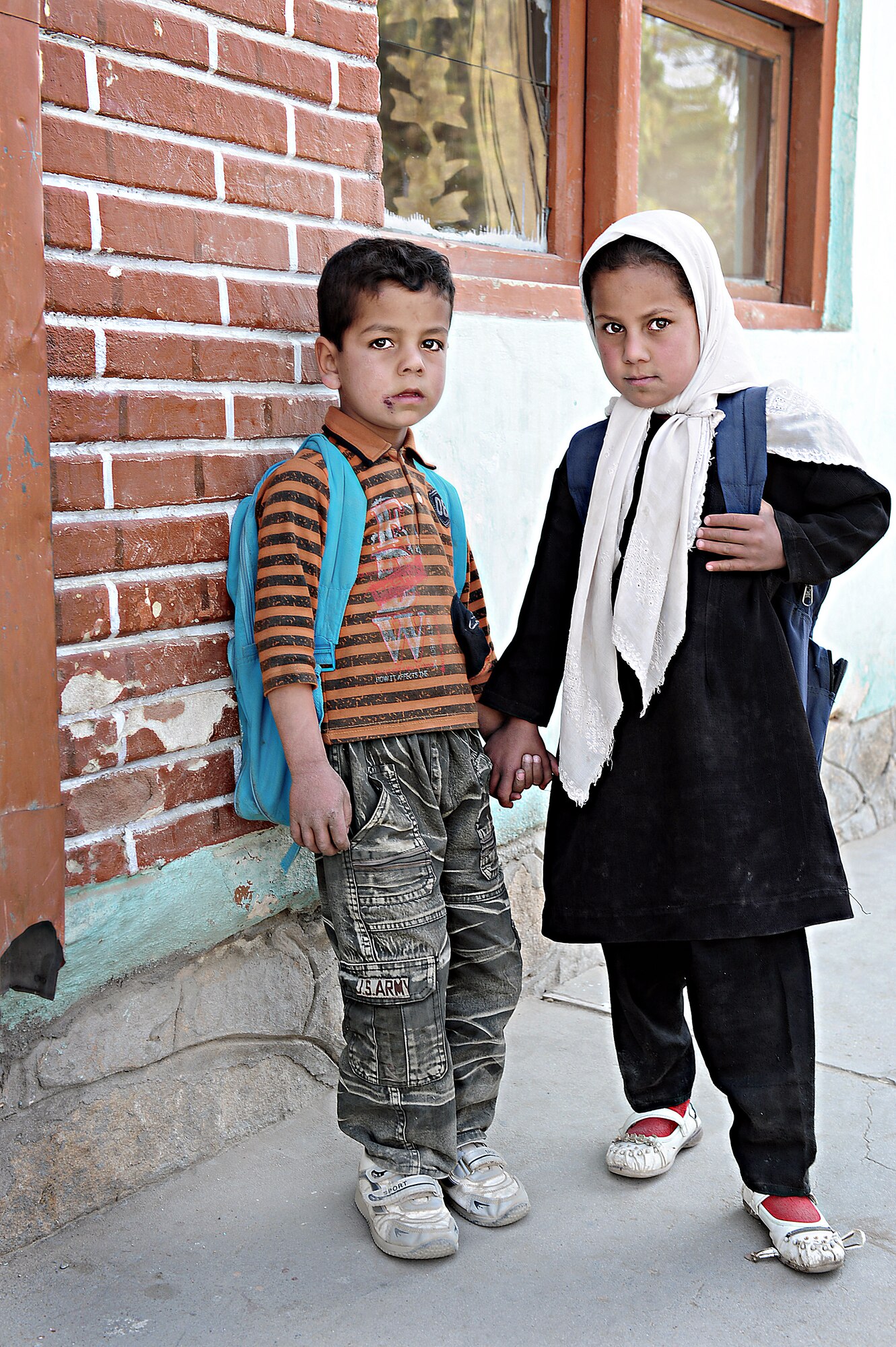 Students from Jahan Maleka School pose for a picture outside during a break Oct. 26, 2010, in Ghazni City. The Ghazni Provincial Reconstruction Team visited the school and donated coloring materials for a drawing contest and to see a program implemented by the U.S. Department of State that emphasizes women's rights. (U.S. Air Force photo/ Senior Airman Courtney Witt)