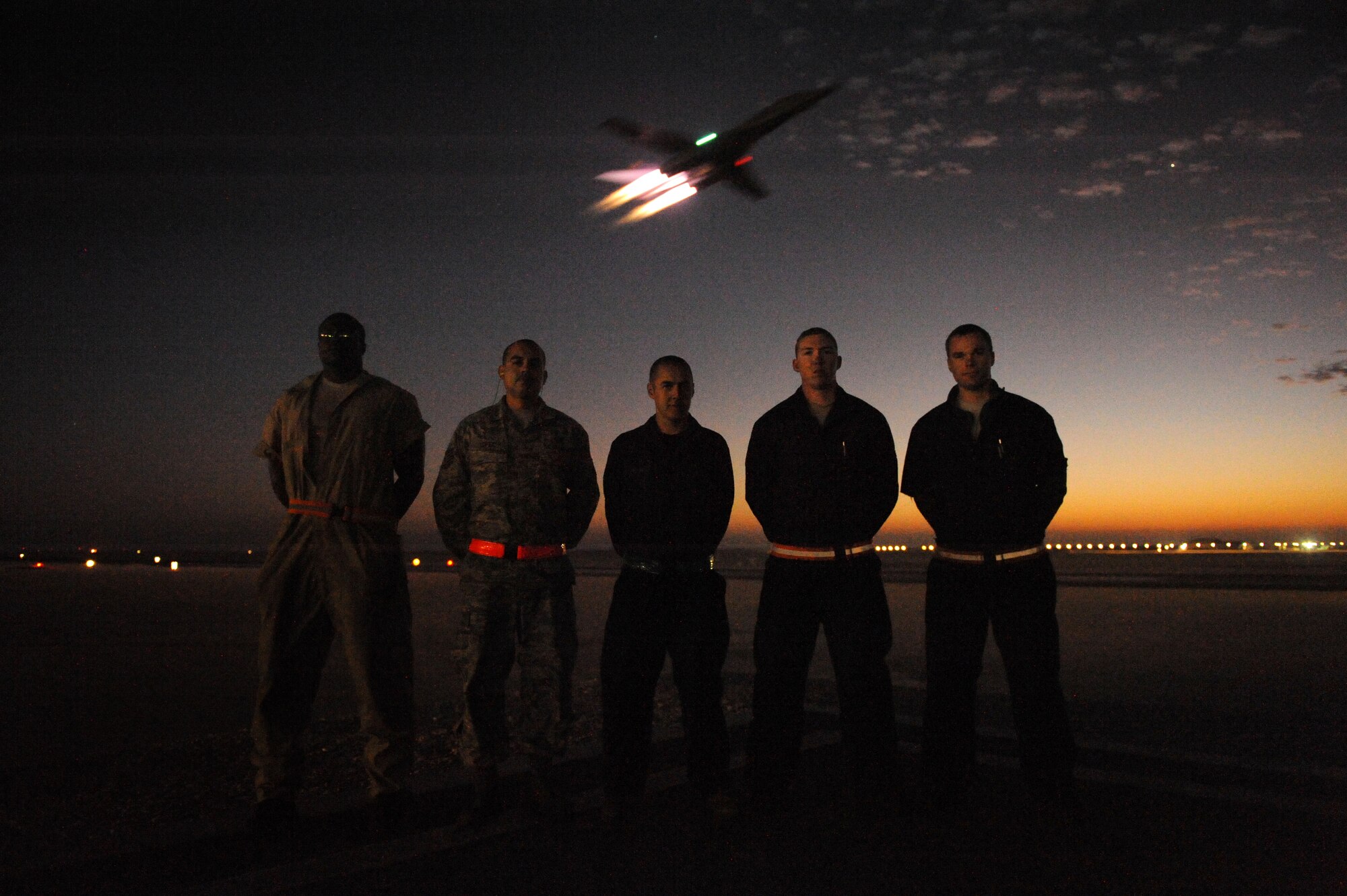 SOUTHWEST ASIA – Airmen from the 34th Expeditionary Aircraft Maintenance Unit stand as the B-1B Lancer they just prepared for a night mission takes off in the background here Dec. 29, 2011. The B-1B is a long-range, multi-role bomber that can be used for a variety of operational missions. The Airmen are deployed from Ellsworth Air Force Base, S.D. (U.S. Air Force photo/Staff Sgt. Nathanael Callon)