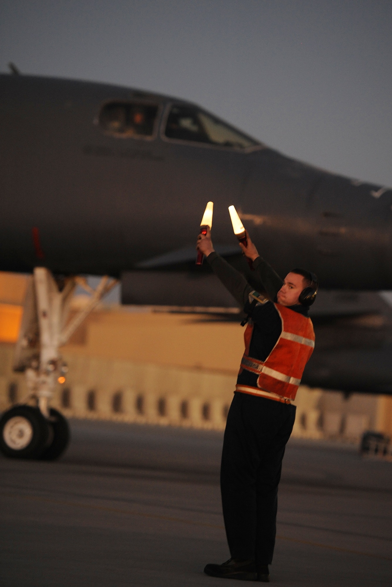 SOUTHWEST ASIA – Airman 1st Class Joseph Dowdell, 34th Expeditionary Aircraft Maintenance Unit and a native of Brunswick, Ohio, marshals a B-1B Lancer onto the taxiway here Dec. 29, 2011. The B-1B is a long-range, multi-role bomber that can be used for a variety of operational missions. Dowdell is deployed from Ellsworth Air Force Base, S.D. (U.S. Air Force photo/Staff Sgt. Nathanael Callon)