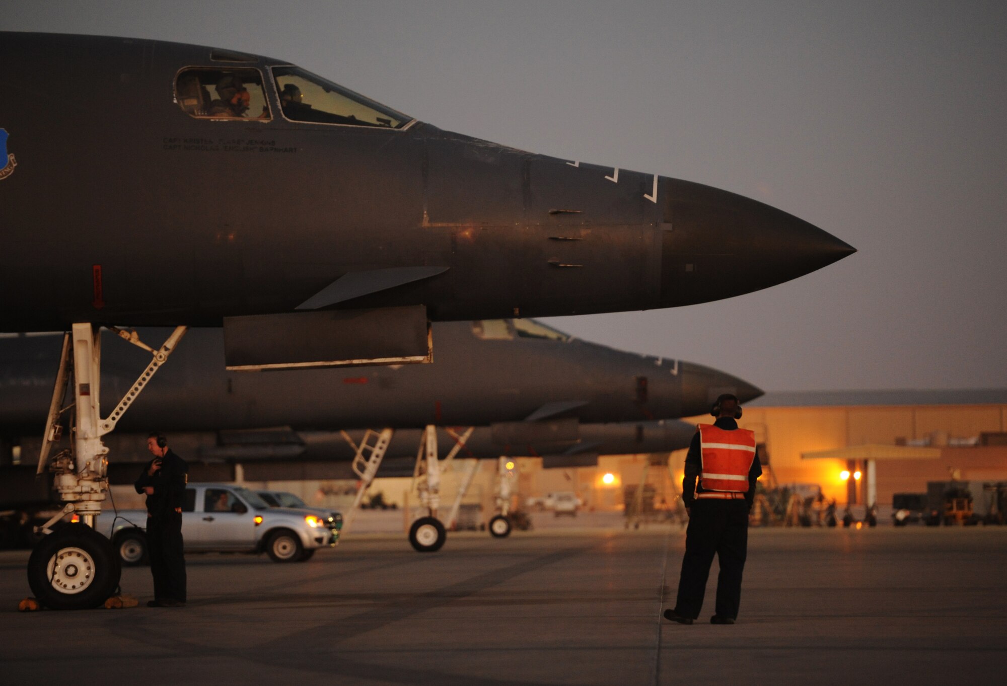 SOUTHWEST ASIA – Airman 1st Class Joseph Dowdell (right), a native of Brunswick, Ohio, and Senior Airman Nick Lunde, a native of Seattle, both crew chiefs from the 34th Expeditionary Aircraft Maintenance Unit, prepare a B-1B Lancer for take-off here Dec. 29, 2011. The B-1B is a long-range, multi-role bomber that can be used for a variety of operational missions. Dowdell and Lunde are deployed from Ellsworth Air Force Base, S.D. (U.S. Air Force photo/Staff Sgt. Nathanael Callon)