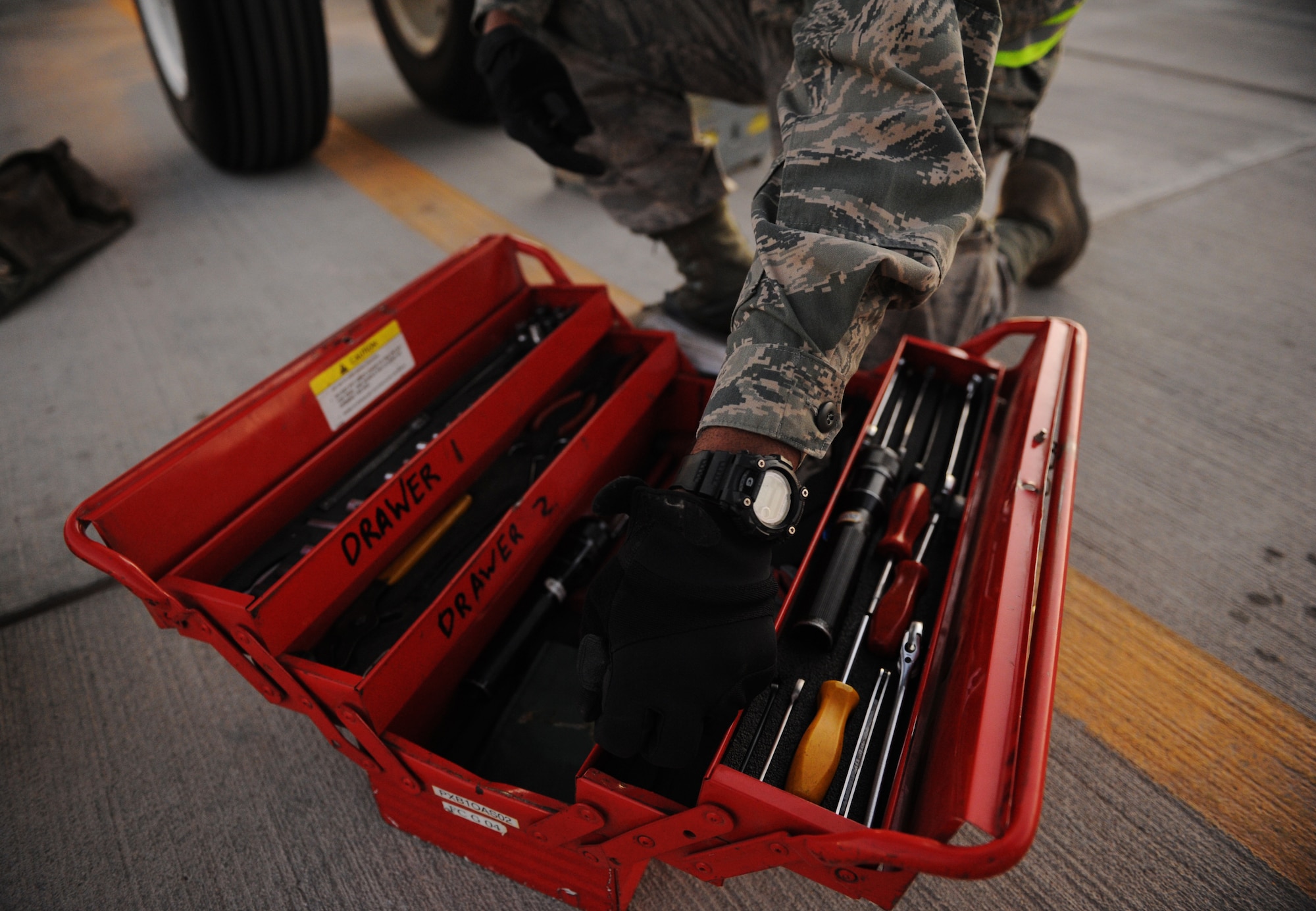SOUTHWEST ASIA – Airman 1st Class Jamal Browne, 34th Expeditionary Aircraft Maintenance Unit avionics specialist and native of Los Angeles, picks out tools before performing maintenance on a B-1B Lancer here Dec. 29, 2011. Avionics specialists are trained to troubleshoot and repair avionics flight equipment to ensure proper communication and functionality in flight. Browne is deployed from Ellsworth Air Force Base, S.D.  (U.S. Air Force photo/Staff Sgt. Nathanael Callon)