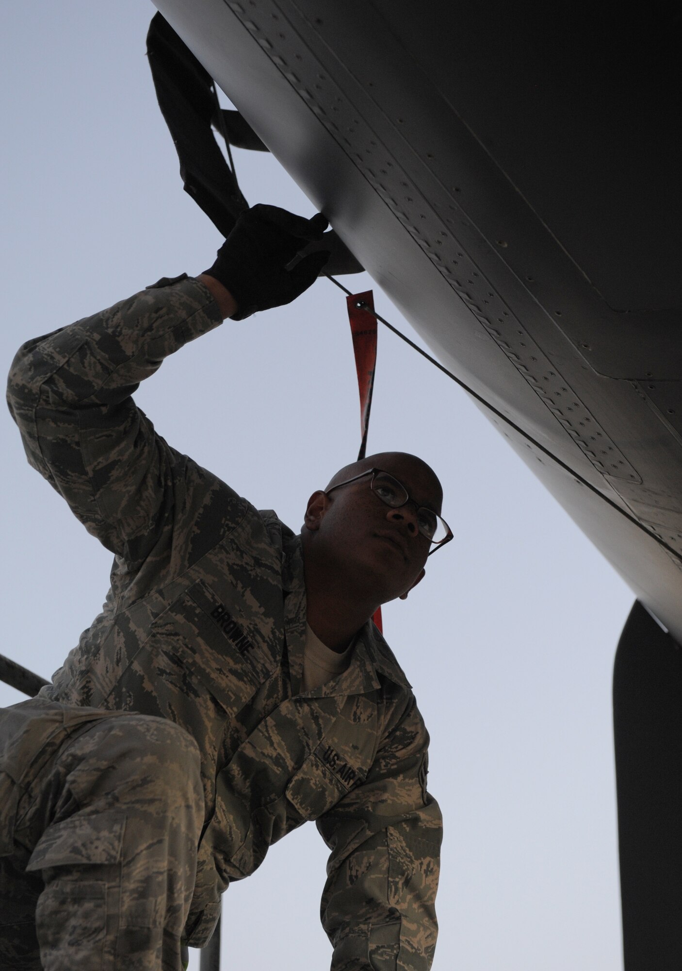 SOUTHWEST ASIA -- Airman 1st Class Jamal Browne, 34th Expeditionary Aircraft Maintenance Unit avionics specialist and native of Los Angeles, prepares to remove a panel on a B-1B Lancer here Dec. 29, 2011. Avionics specialists are trained to troubleshoot and repair avionics flight equipment to ensure proper communication and functionality in flight. Browne is deployed from Ellsworth Air Force Base, S.D. (U.S. Air Force photo/Staff Sgt. Nathanael Callon)