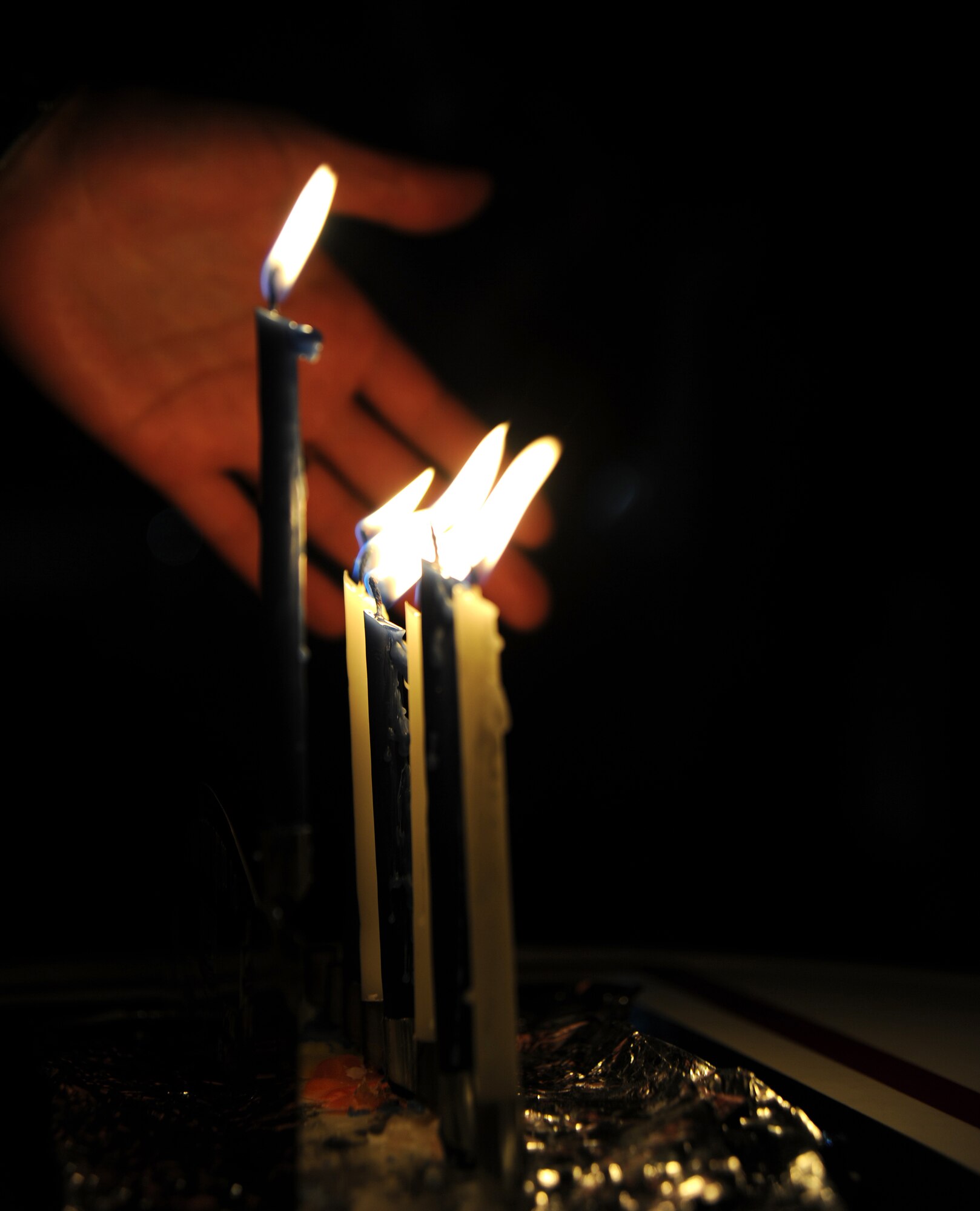 "Once lit, Menorah candles are traditionally not to be left alone," 1st Lt. Jonathan Goldstein, a pilot with the 817th Air Expeditionary Airlift Squadron (Detachment 1), explains, Dec. 25, 2011, at the Transit Center at Manas, Kyrgyzstan. Goldstein, deployed from Joint Base Lewis-McChord, Wash., spent each evening during Hanukkah adding a candle and sharing the story of the holiday. 
(U.S. Air Force photo/Master Sgt. Tracy L. DeMarco)
