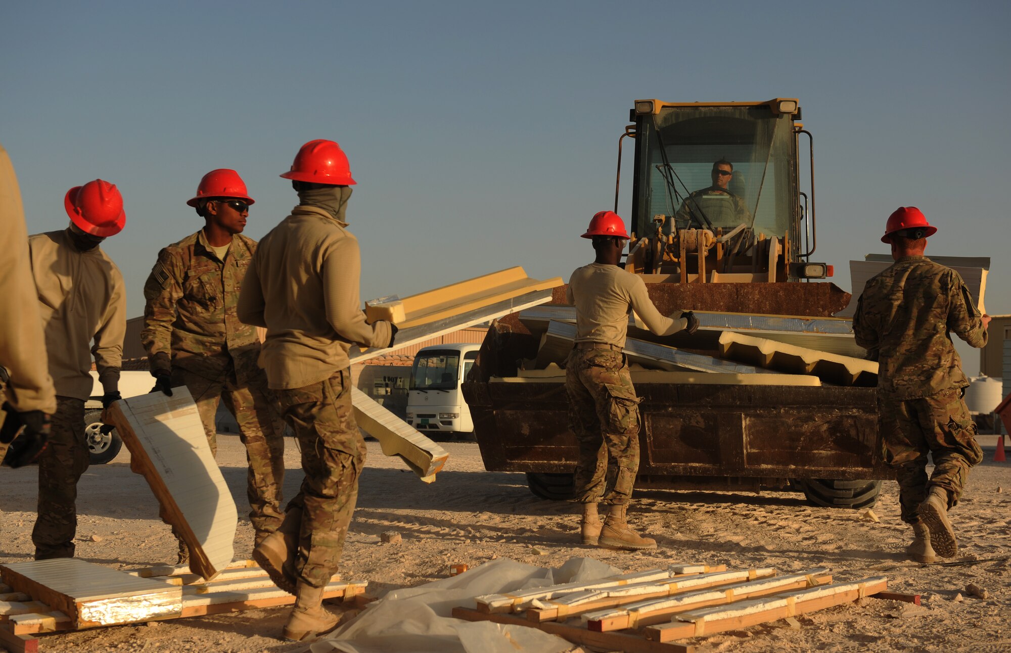 SOUTHWEST ASIA – Airmen from the 557th Expeditionary RED HORSE Squadron clean up piles of excess trim here Dec. 28, 2011. The 557th ERHS is constructing a 9,000-square foot complex which will house the 1st Expeditionary RED HORSE Group. RED HORSE stands for Rapid Engineer Deployable, Heavy Operations Repair Squadrons, Engineer. (U.S. Air Force photo/Staff Sgt. Nathanael Callon)
