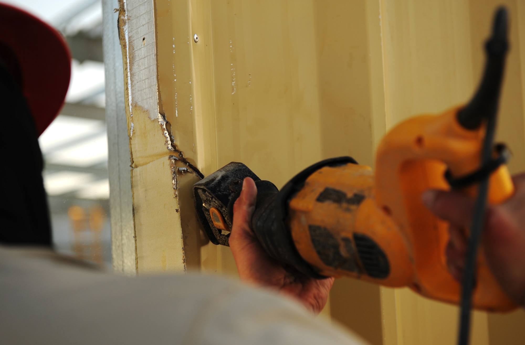 SOUTHWEST ASIA – Airman 1st Class Clayton Crocker, 557th Expeditionary RED HORSE Squadron team member and native of Davie, Fla., saws away excess trim on a new RED HORSE facility here Dec. 28, 2011. The facility will be the home for the 1st Expeditionary RED HORSE Group, which oversees all Air Force construction operations throughout Southwest Asia. Crocker is deployed from Nellis Air Force Base, Nev. RED HORSE stands for Rapid Engineer Deployable, Heavy Operations Repair Squadrons, Engineer. (U.S. Air Force photo/Staff Sgt. Nathanael Callon)