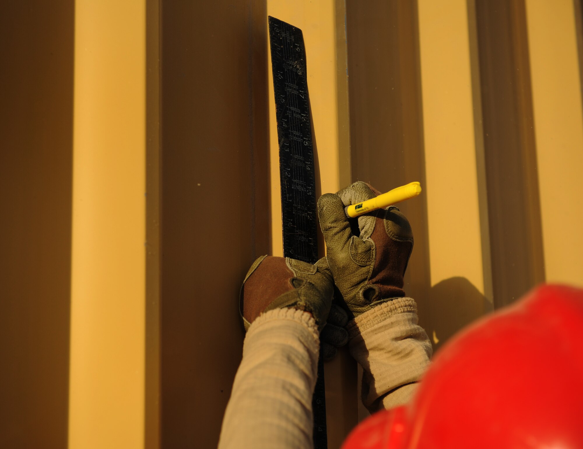 SOUTHWEST ASIA – Airman 1st Class Matthew Davis, 557th Expeditionary RED HORSE Squadron team member and native of DeKalb, Texas, takes measurements before riveting pieces of wall together on a new RED HORSE facility here Dec. 28, 2011. The 9,000-square foot complex will house the 1st Expeditionary RED HORSE Group Headquarters. Davis is deployed from Nellis Air Force Base, Nev. RED HORSE stands for Rapid Engineer Deployable, Heavy Operations Repair Squadrons, Engineer. (U.S. Air Force photo/Staff Sgt. Nathanael Callon)