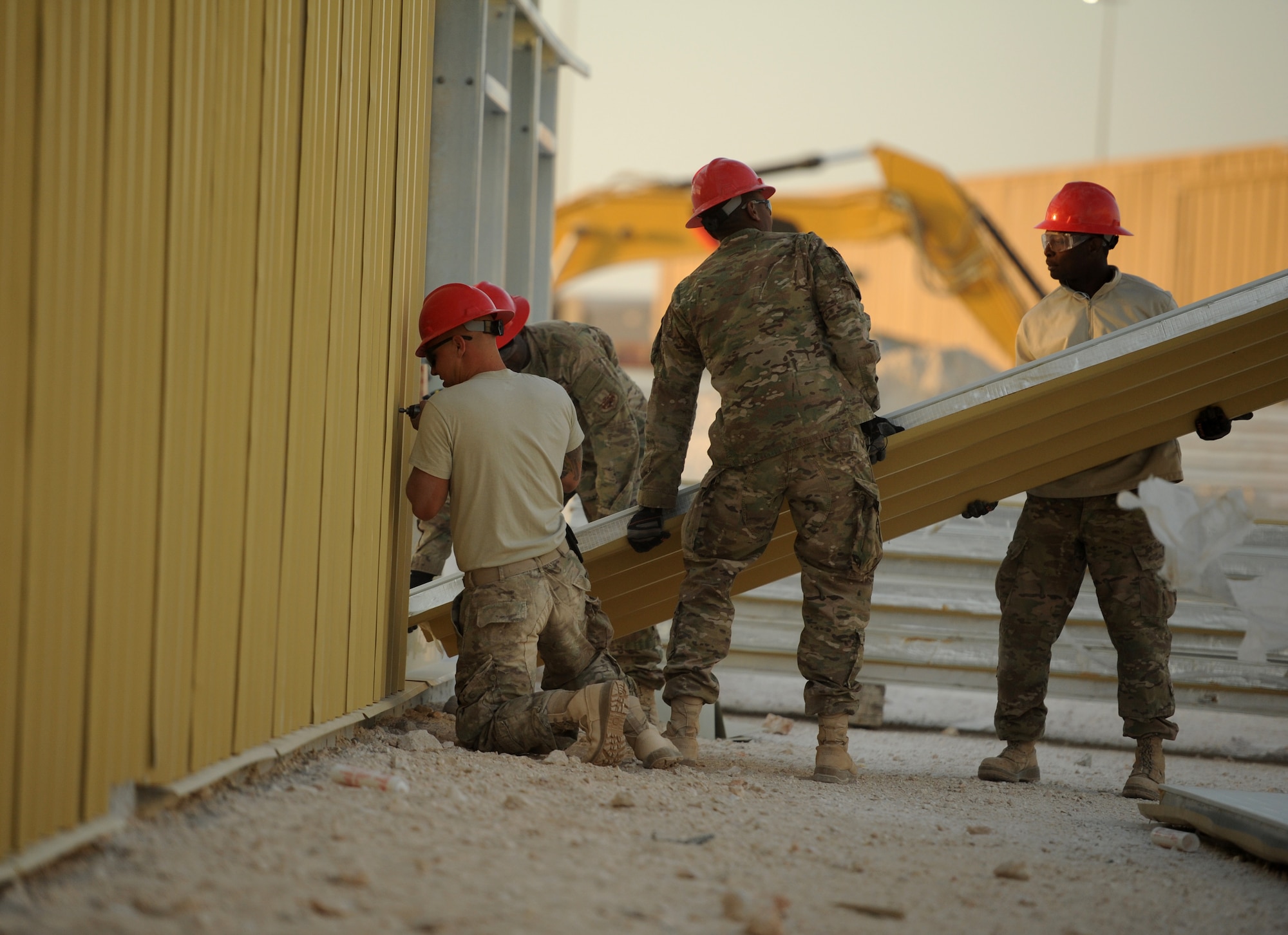SOUTHWEST ASIA – Airmen from the 557th Expeditionary RED HORSE Squadron attach walls to the frame of a new RED HORSE facility here Dec. 27, 2011. The facility is the new home of the 1st Expeditionary RED HORSE Group, which oversees all Air Force construction operations throughout Southwest Asia. RED HORSE stands for Rapid Engineer Deployable, Heavy Operations Repair Squadrons, Engineer. (U.S. Air Force photo/Staff Sgt. Nathanael Callon)