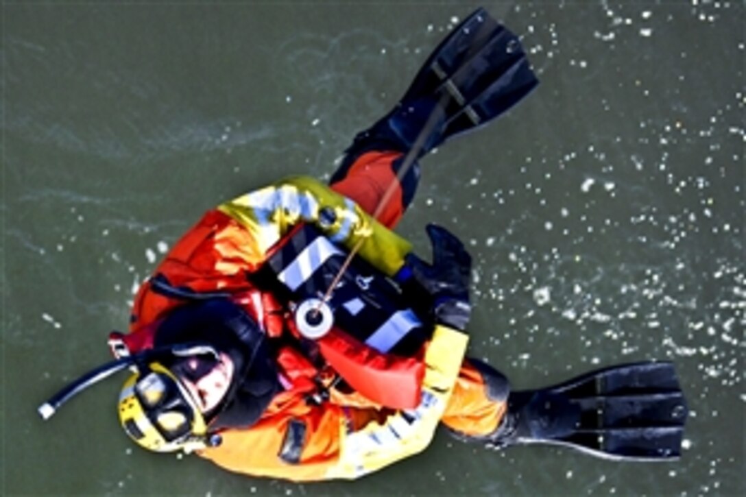 An MH-60 Jay Hawk helicopter hoists Coast Guard Petty Officer 3rd class Darren Hicks while conducting rescue swimmer training in the James River near Portsmouth, Va., Dec. 28, 2011. The Jay Hawk crew is assigned to Air Station Elizabeth City, N.C., and train regularly in swimmer deployments and water recoveries. 