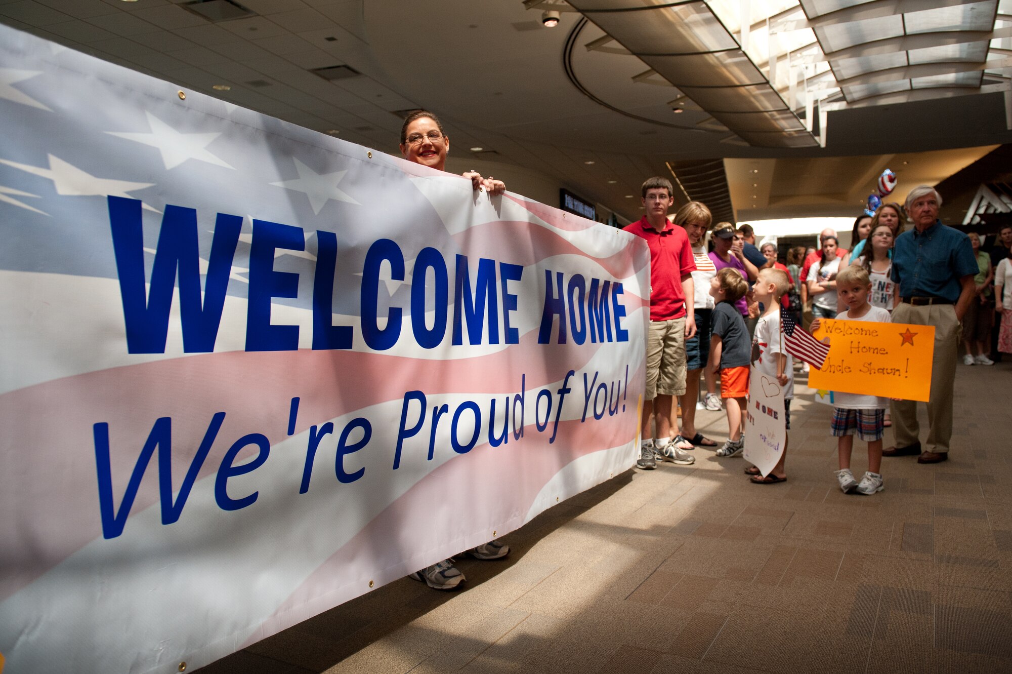 Friends and family of more than a dozen Kentucky Air National Guardsmen wait to greet the troops at Louisville International Airport in Louisville, Ky., as they return from a six-month deployment to Afghanistan on June 25, 2011. The Airmen are the first of more than 40 members of the Kentucky Air Guard's 123rd Civil Engineering Squadron who will be returning from Bagram Airfield, Afghanistan, through July. The Kentucky Airmen comprised approximately 60 percent of Bagram's 455th Expeditionary Civil Engineer Squadron during the deployment in support of Operation Enduring Freedom, managing maintenance and construction for the 1,000-acre base and its 11,000-foot runway. The squadron completed over 60 construction projects worth more than $300 million during the past six months, including a new C-130 aircraft hangar, a 1,500-foot road and base housing for 500 personnel. (U.S. Air Force photo by Maj. Dale Greer)