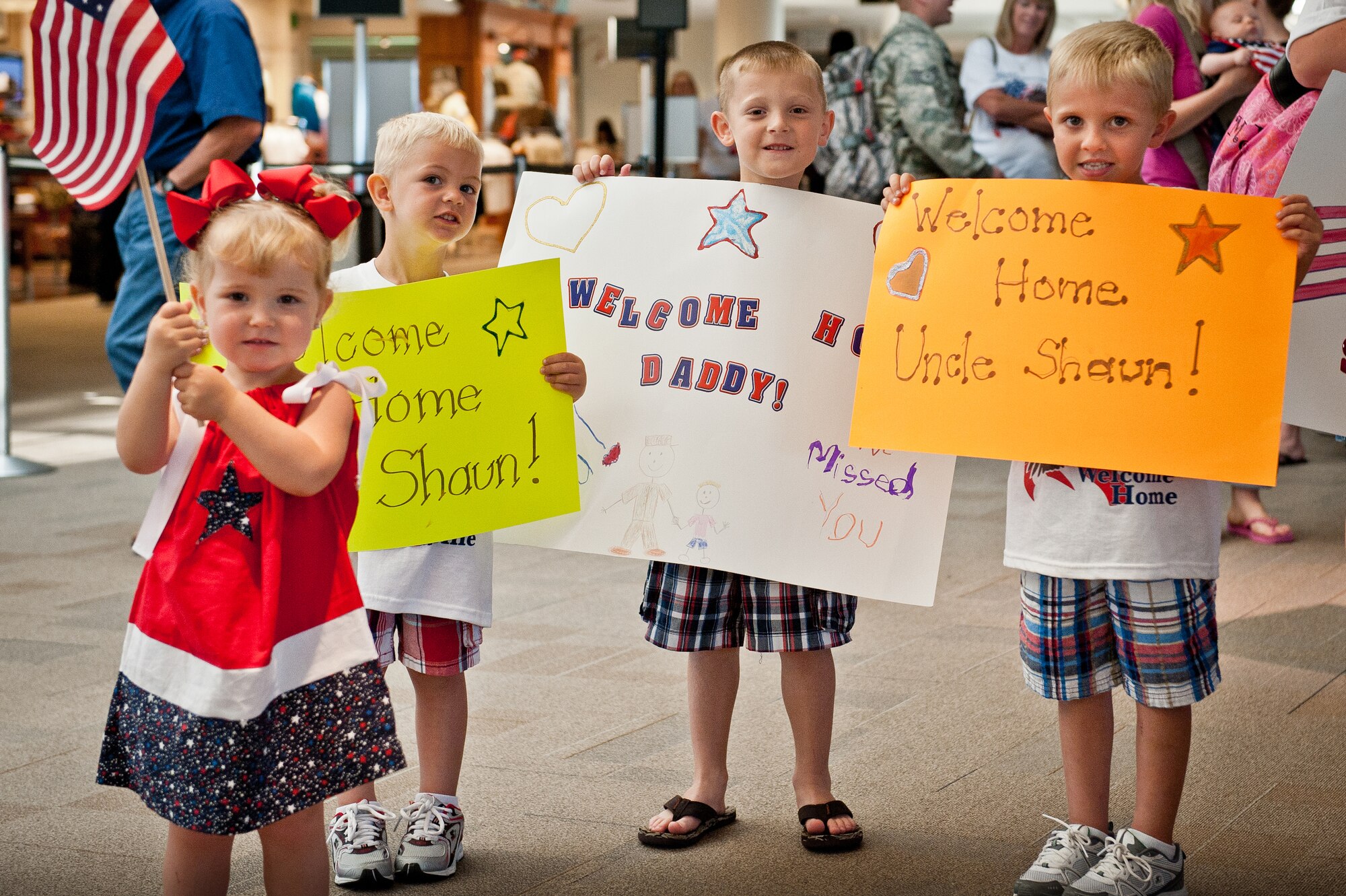 The daughter, son and nephews of Master Sgt. Shaun Cecil, an electrician in the Kentucky Air National Guard's 123rd Civil Engineer Squadron, wait excitedly at Louisville International Airport in Louisville, Ky.,  for Sergeant Cecil and more than a dozen of his coworkers to return from a six-month deployment to Afghanistan on June 25, 2011. The Airmen were among more than 40 Kentucky Air Guard civil engineers who have been stationed at Bagram Airfield, Afghanistan, where they comprised approximately 60 percent of Bagram's 455th Expeditionary Civil Engineer Squadron. The unit managed maintenance and construction for the 1,000-acre base and its 11,000-foot runway, completing over 60 construction projects worth more than $300 million during the past six months. (U.S. Air Force photo by Maj. Dale Greer)