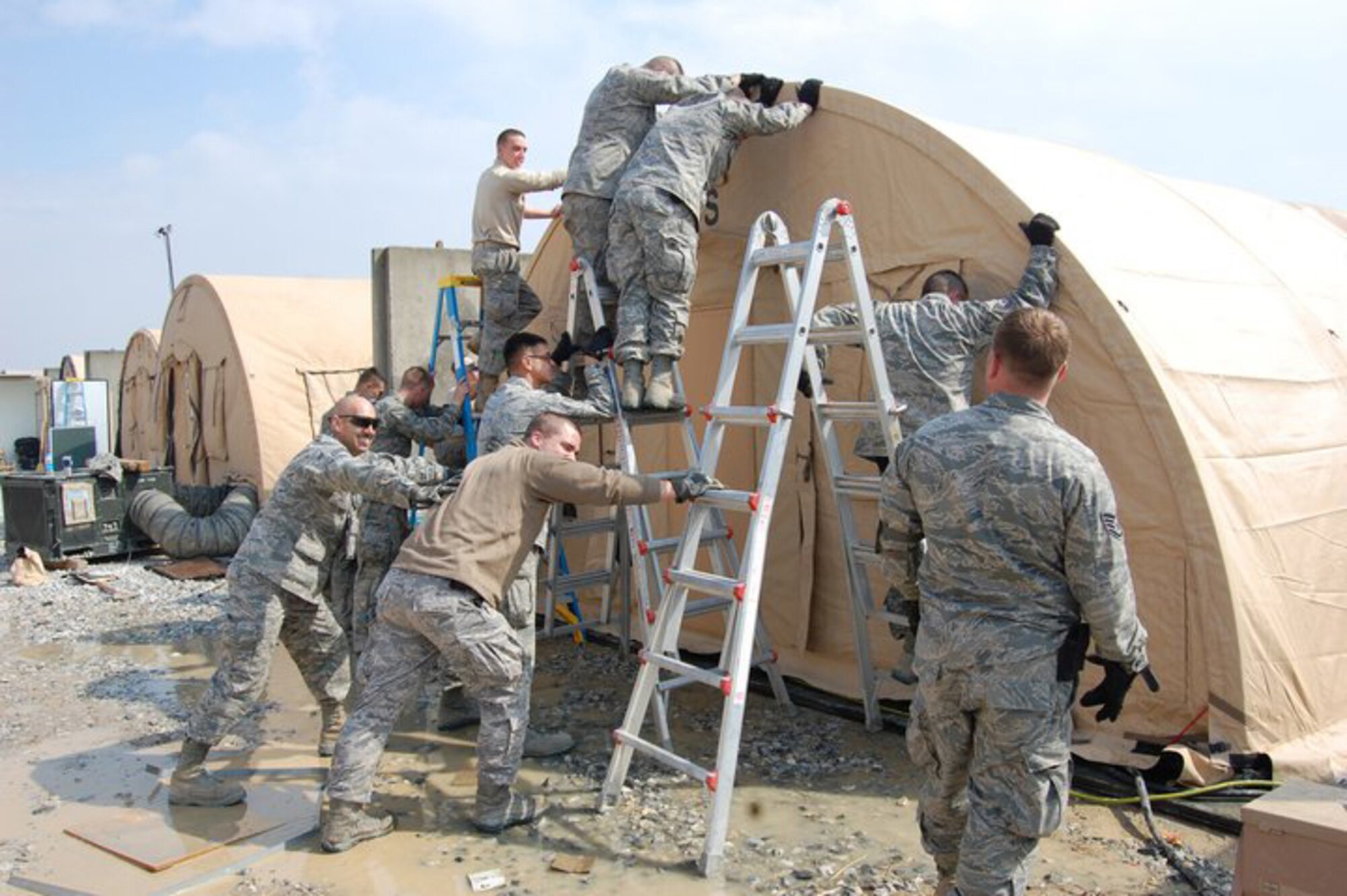 Chief Master Sgt. Steve Peters directs Airmen of the 455th Expeditionary Civil Engineer Squadron March 6, 2011, as they construct an Alaskan Shelter at Bagram Airfield, Afghanistan. The unit completed more than $300 million worth of construction projects during a six-moth tour in support of Operation Enduring Freedom. (U.S. Air Force photo by Staff Sgt. Desiree Blair)