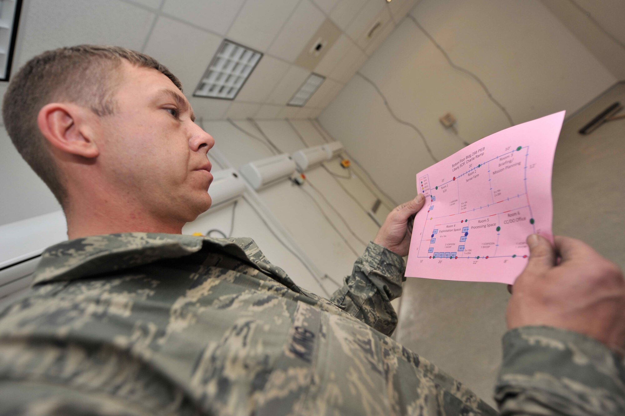 Master Sgt. Russ King, a Kentucky Air Guard electrician, reviews a wiring schematic March 2, 2011,  to ensure that electrical installations are complete in a new building being constructed at  Bagram Airfield, Afghanistan. When not deployed, King is assigned to the Louisville, Ky.-based 123rd Civil Engineer Squadron. (U.S. Air Force photo by Senior Airman Sheila deVera)