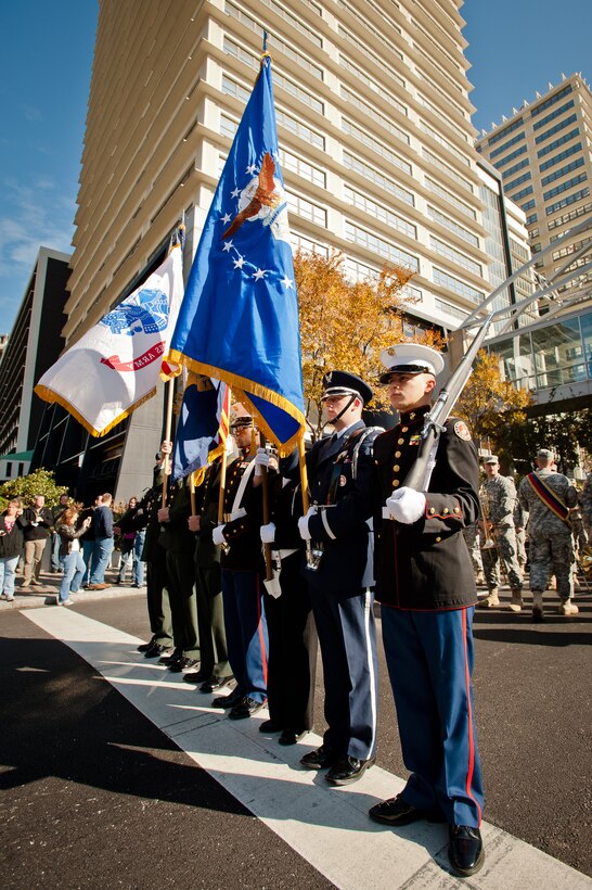 The city of Louisville, Ky., celebrates Veterans Day Nov. 11, 2011, with a Main Street parade and Massing of the Colors ceremony that showcased dozens of color guard details from every branch of the U.S. military, numerous veterans' groups and a variety of government agencies like the Louisville Metro Fire Department.  The parade began with a three-ship C-130 flyover, courtesy of the Kentucky Air National Guard's 123rd Airlift Wing. The wing's 123rd Force Support Squadron also coordinated a joint-service color guard, shown here, that led the parade down Main Street. (U.S. Air Force photo by Maj. Dale Greer)