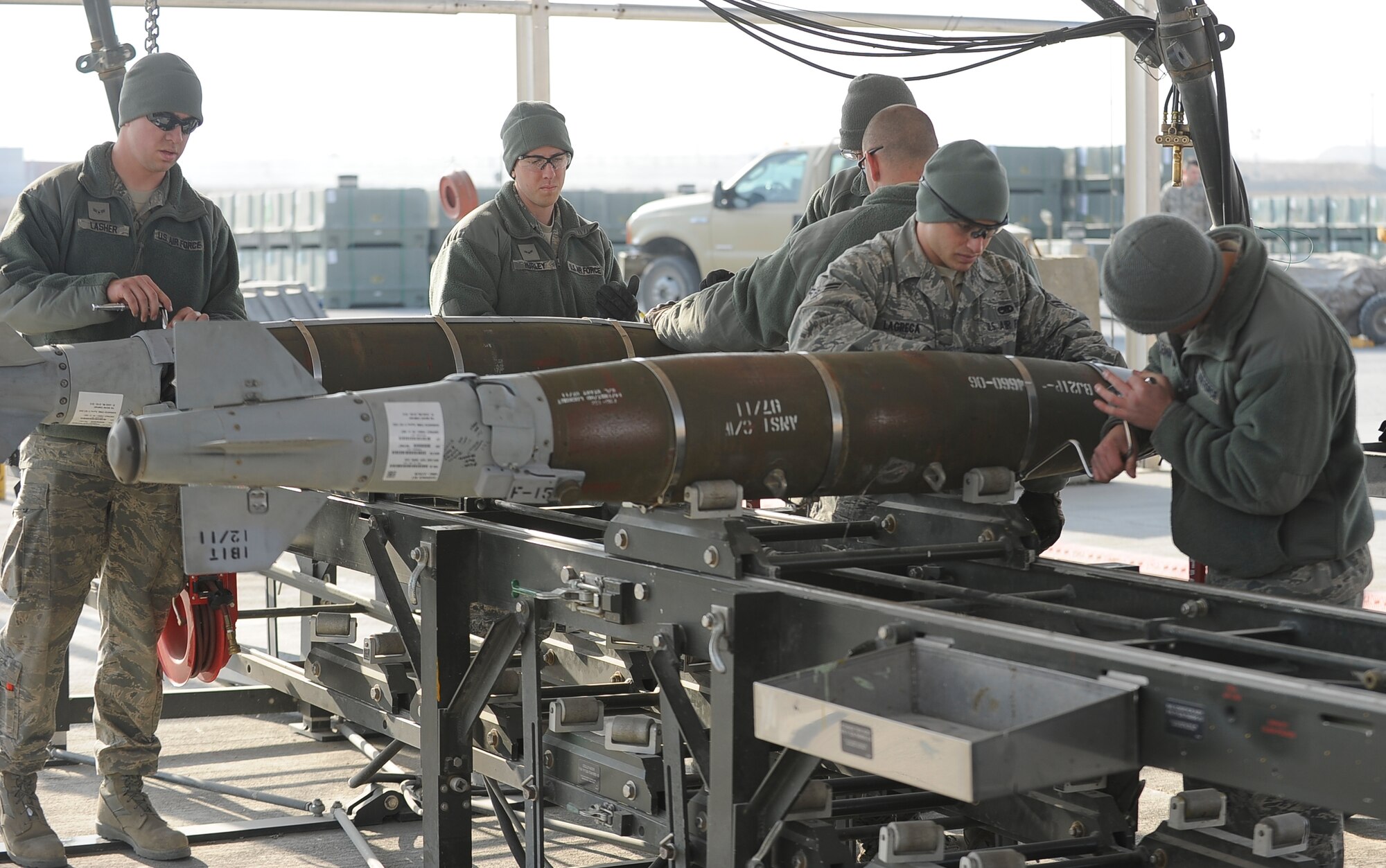 Ammo Dawgs from the 455th Expeditionary Maintenance Squadron reassemble two bombs inspected during an assembled munitions serviceability inspection at Bagram Airfield, Afghanistan, Dec. 28, 2011. Ammo Airmen receive, inspect, issue, assemble and test, maintain, inventory and transport guided and unguided munitions.  An AMSI was done twice a year to ensure all munitions in stock were ready to be deployed when needed to be dropped on target.  (U.S. Air Force photo/Tech. Sgt. Vernon Cunningham)