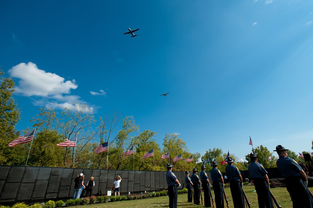 Two Kentucky Air Guard C-130s conduct a flyover at Resthaven Memorial Park in Louisville, Ky., on Sept. 11, 2011, during a 9/11 observance and the closing ceremonies for the Dignity Memorial Vietnam Wall, a 3/4-scale replica of the Vietnam Veteran's Memorial in Washington, D.C., that has been exhibited in more than 200 cities across the country since 1990. (U.S. Air Force photo by Maj. Dale Greer)