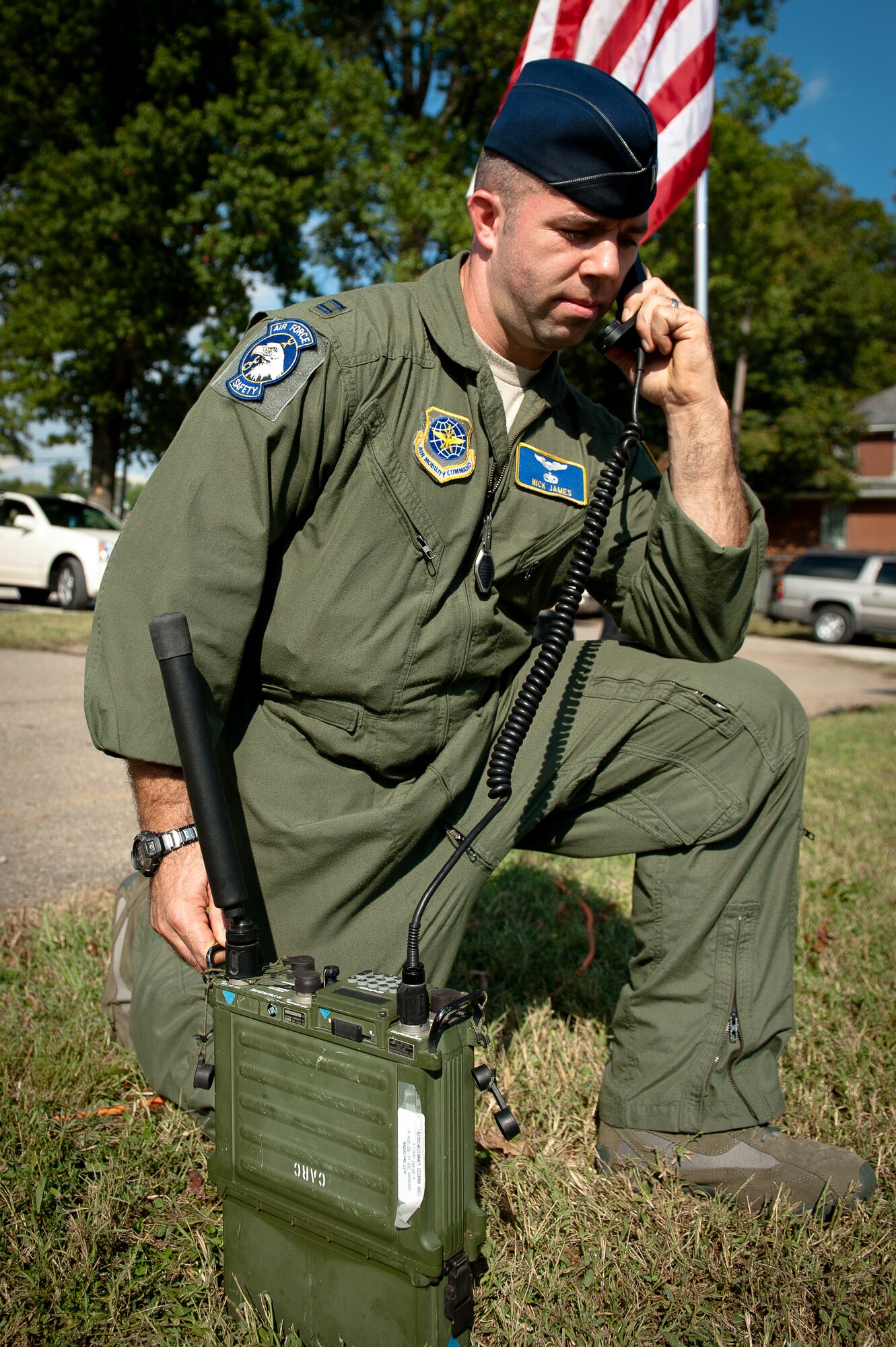 Capt. Nick James of the 123rd Airlift Wing Safety Office uses a two-way radio to communicate with the pilots of two Kentucky Air Guard C-130s as the aircraft are positioned for a flyover at Resthaven Memorial Park in Louisville, Ky., on Sept. 11, 2011. The fly-by was part of a 9/11 observance and the closing ceremonies for the Dignity Memorial Vietnam Wall, a 3/4-scale replica of the Vietnam Veteran's Memorial in Washington, D.C., that has been exhibited in more than 200 cities across the country since 1990. (U.S. Air Force photo by Maj. Dale Greer)