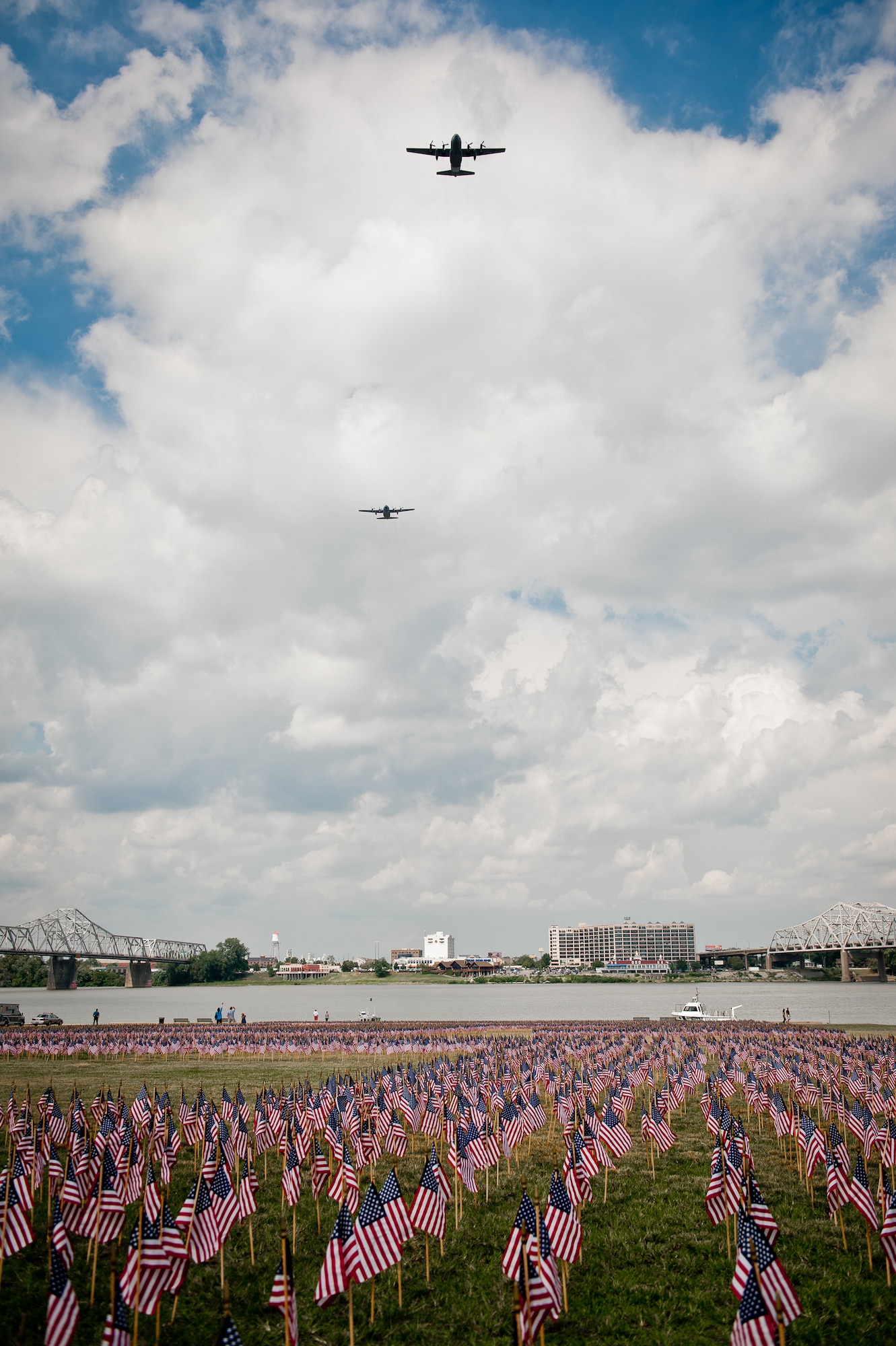 Two C-130 aircraft from the Kentucky Air National Guard's 123rd Airlift Wing fly over Waterfront Park in Louisville, Ky., on Sept. 11, 2011, during city's 10th anniversary observance of the 9/11 terrorist attacks on the United States. (U.S. Air Force photo by Maj. Dale Greer)