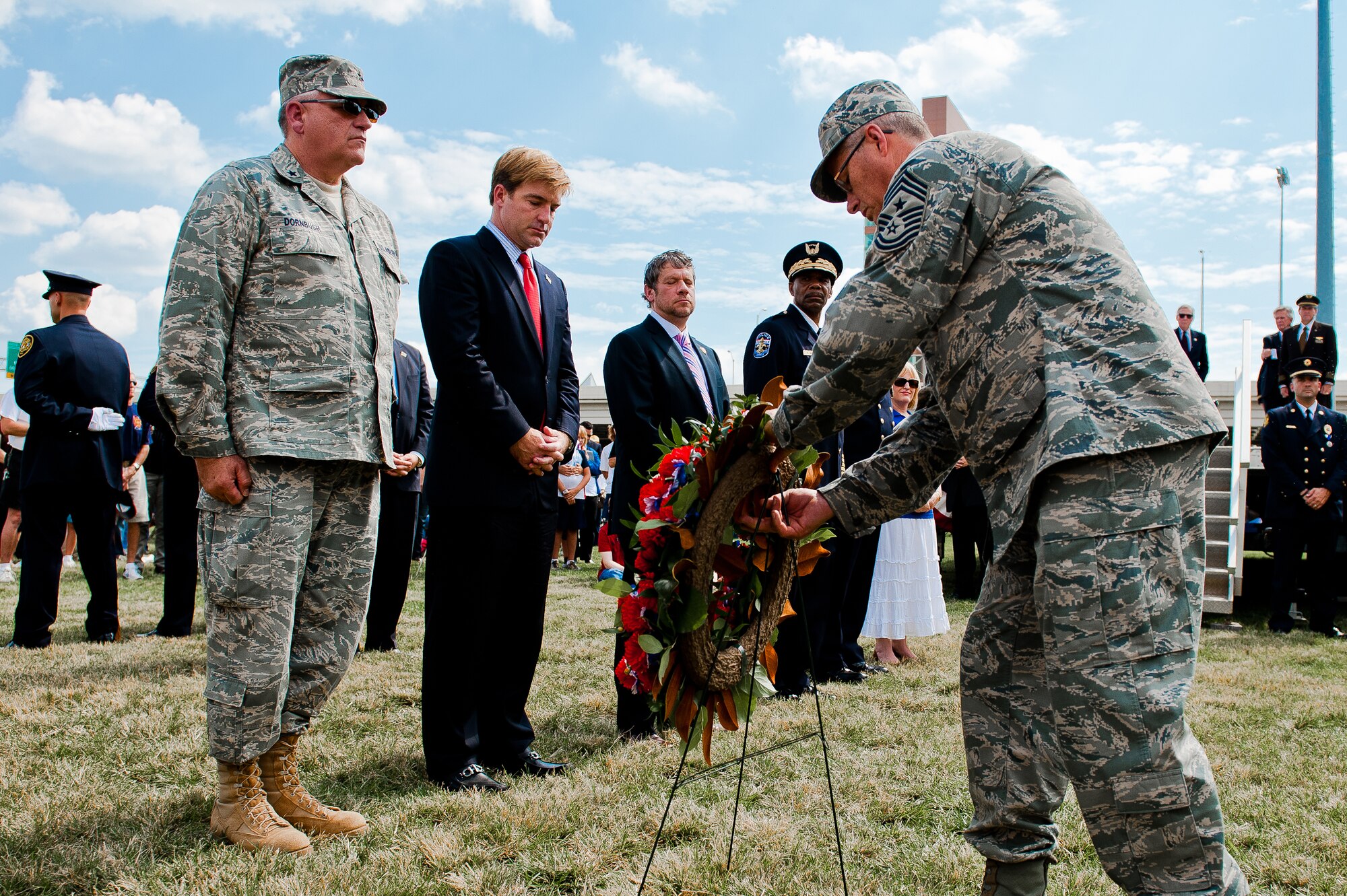Brig. Gen. Michael Dornbush (left), chief of joint staff for the Kentucky National Guard's Joint Forces Headquarters, and Chief Master Sgt. James Smith, state command chief master sergeant (right), prepare to place a wreath in front of the 9/11 Memorial Sculpture at Waterfront Park in Louisville, Ky., Sept. 11, 2011, during city's 10th anniversary observance of the 9/11 terrorist attacks on the United States. The sculpture is made from steel taken from the wreckage of the World Trade Center. (U.S. Air Force photo by Maj. Dale Greer)