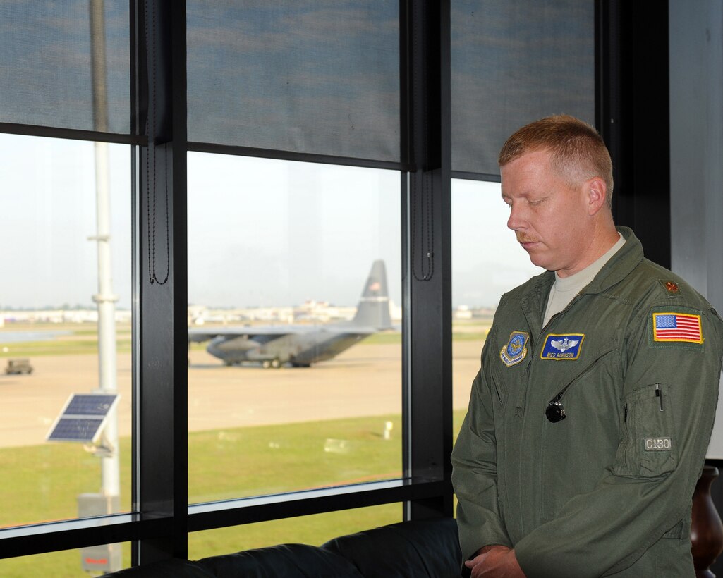 Maj. Wes Robinson, an aircrew member in the 123rd Airlift Wing, pauses for a moment of silence at the Kentucky Air National Guard Base in Louisville, Ky., on Sept. 11, 2011. The reflection was part of the unit's 10th anniversary observance of the 9/11 terrorist attacks on the United States. (U.S. Air Force photo by Tech. Sgt. Dennis Flora)