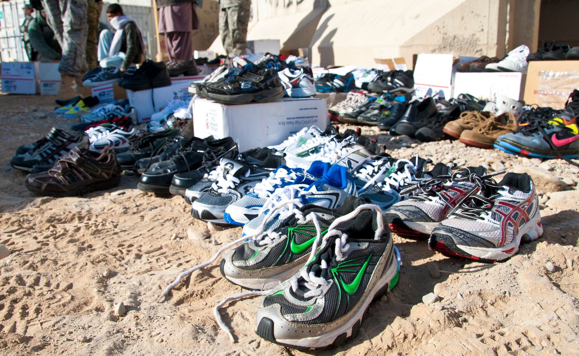 KANDAHAR AIRFIELD, Afghanistan -- Shoes are set out for local Afghan children to try on and take at the Bazaar School at Kandahar Airfield, Afghanistan, Dec. 31, 2011. Volunteers throughout Kandahar collected more than 600 shoes to provide to children. The volunteers also fitted the children in the correct shoe sizes to educate them on the importance of proper shoe fitting. (U.S. Air Force photo by Staff Sgt. David Carbajal)