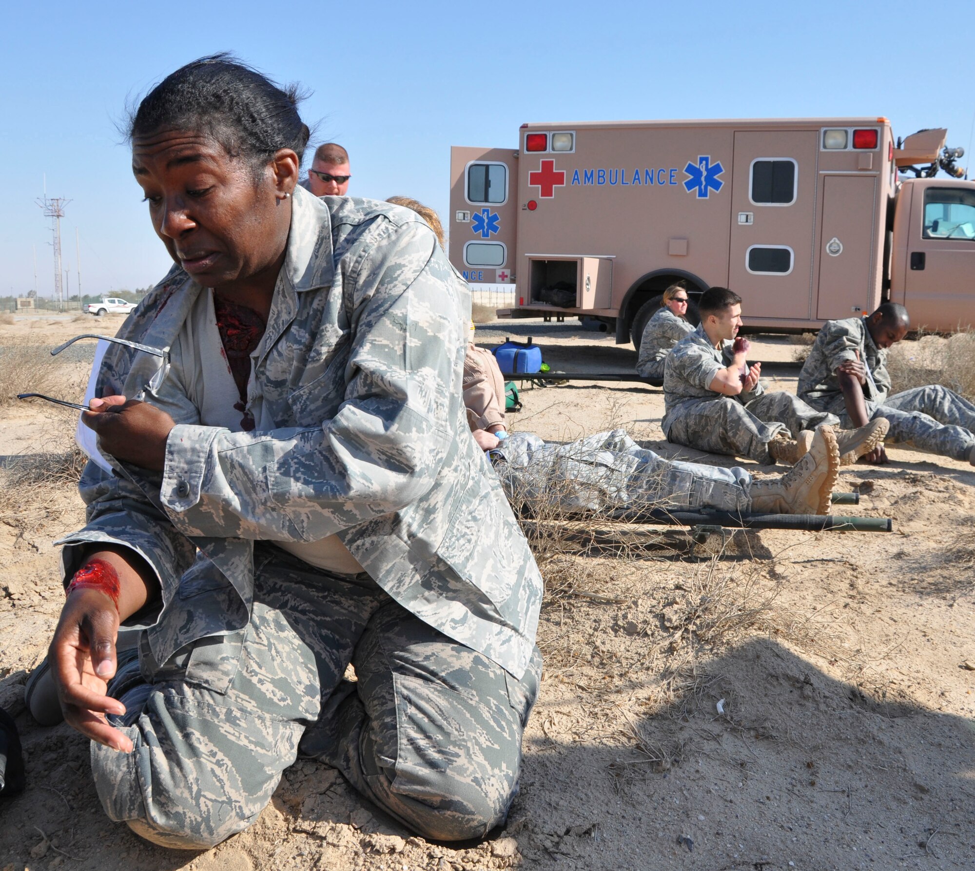 SOUTHWEST ASIA -- Simulated casualties await triage after a simulated aircraft crash during the major accident response exercise Dec. 29, 2011.  Medical technicians moulaged volunteers with various wounds to add realism to the medical portion of the MARE here. (U.S. Air Force photo/Staff. Sgt. Michael McCool)